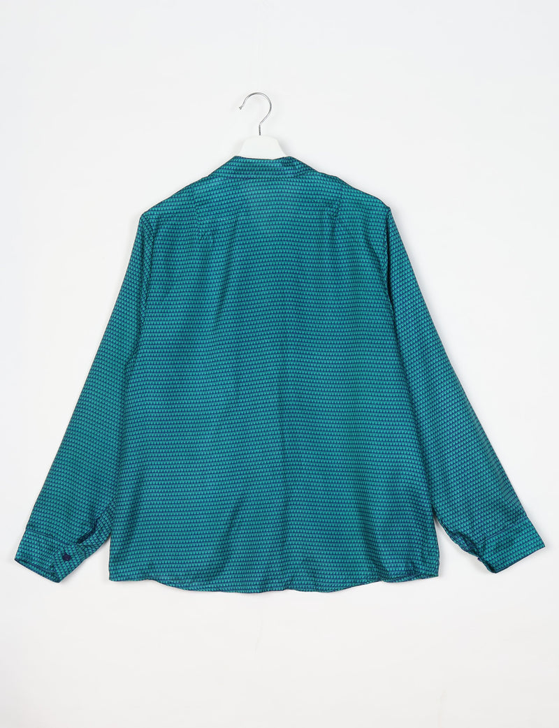 Blue long-sleeve shirt with micro geometric pattern, shown from back on white hanger against white background