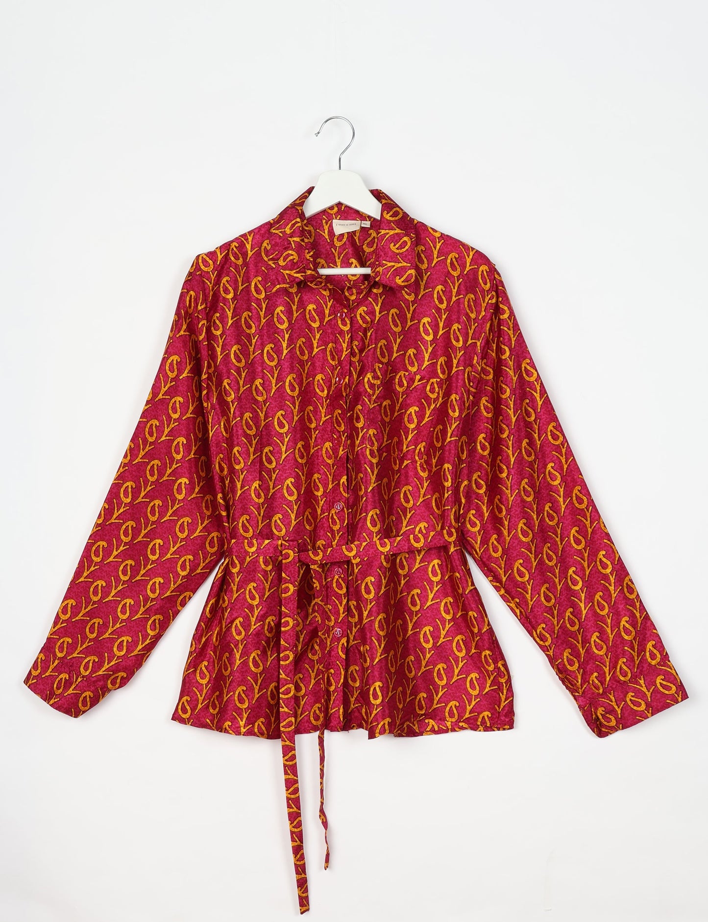 Experience sustainable fashion with our classic slim-fit shirt, crafted with ethical and green values. The shirt, designed for minimal waste, features a tie-up waist belt or neck tie, semi-spread collar, and regular shirt cuffs. Versatile and eco-friendly, wear it tucked in, unbuttoned over a tank top, or knotted at the waist for a unique style.