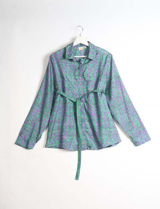 Experience sustainable fashion with our classic slim-fit shirt, crafted with ethical and green values. The shirt, designed for minimal waste, features a tie-up waist belt or neck tie, semi-spread collar, and regular shirt cuffs. Versatile and eco-friendly, wear it tucked in, unbuttoned over a tank top, or knotted at the waist for a unique style.