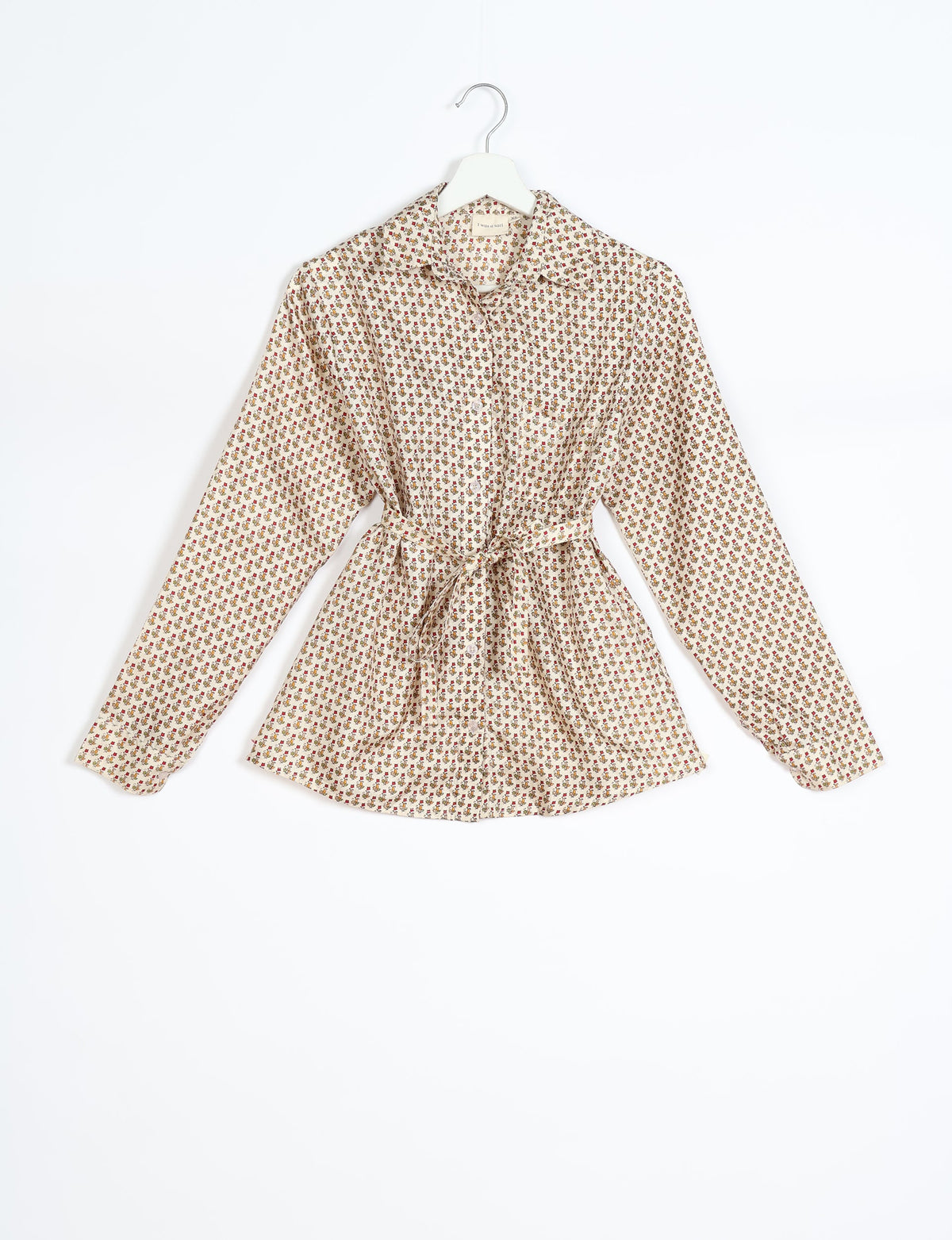 Experience sustainable fashion with our classic slim-fit shirt, crafted with ethical and green values. The shirt, designed for minimal waste, features a tie-up waist belt or neck tie, semi-spread collar, and regular shirt cuffs. Versatile and eco-friendly, wear it tucked in, unbuttoned over a tank top, or knotted at the waist for a unique style.
