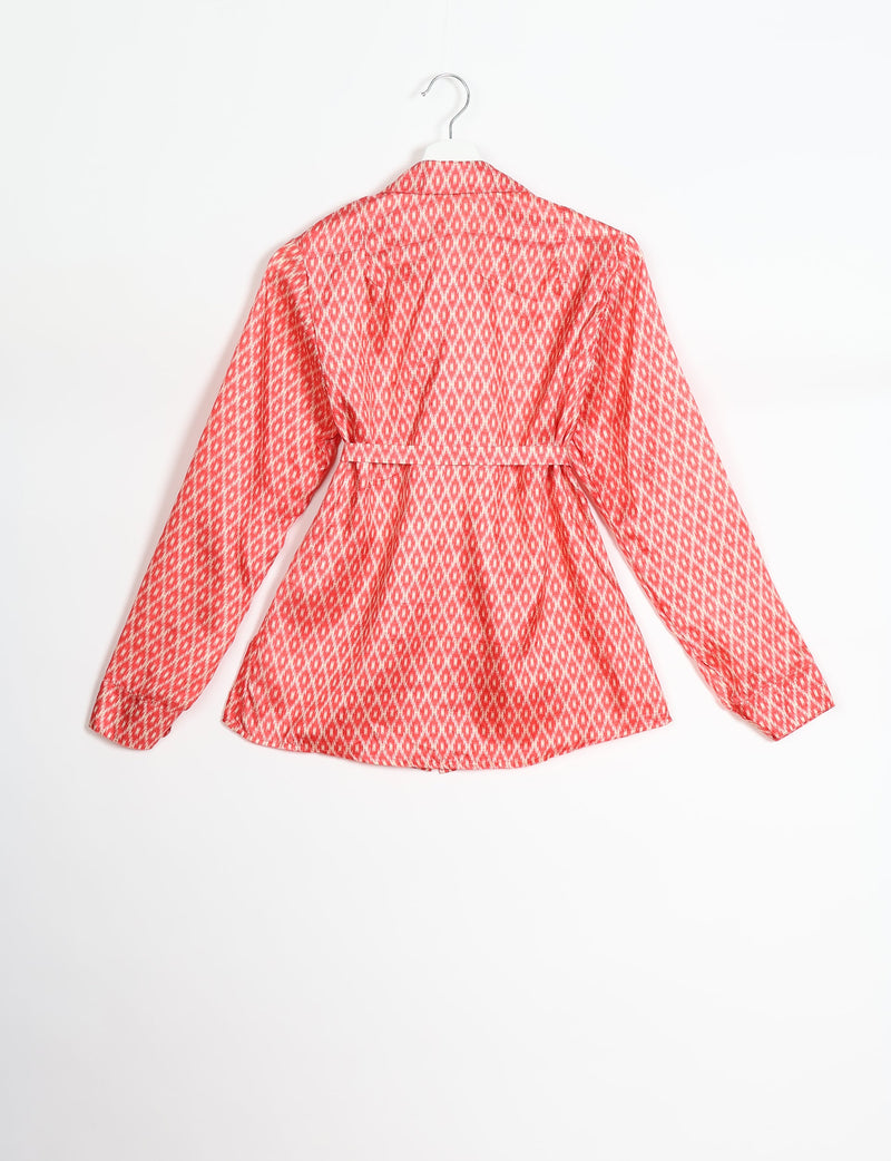 Pink long-sleeve shirt with white geometric pattern, belt detail at waist, shown from back on hanger against white background