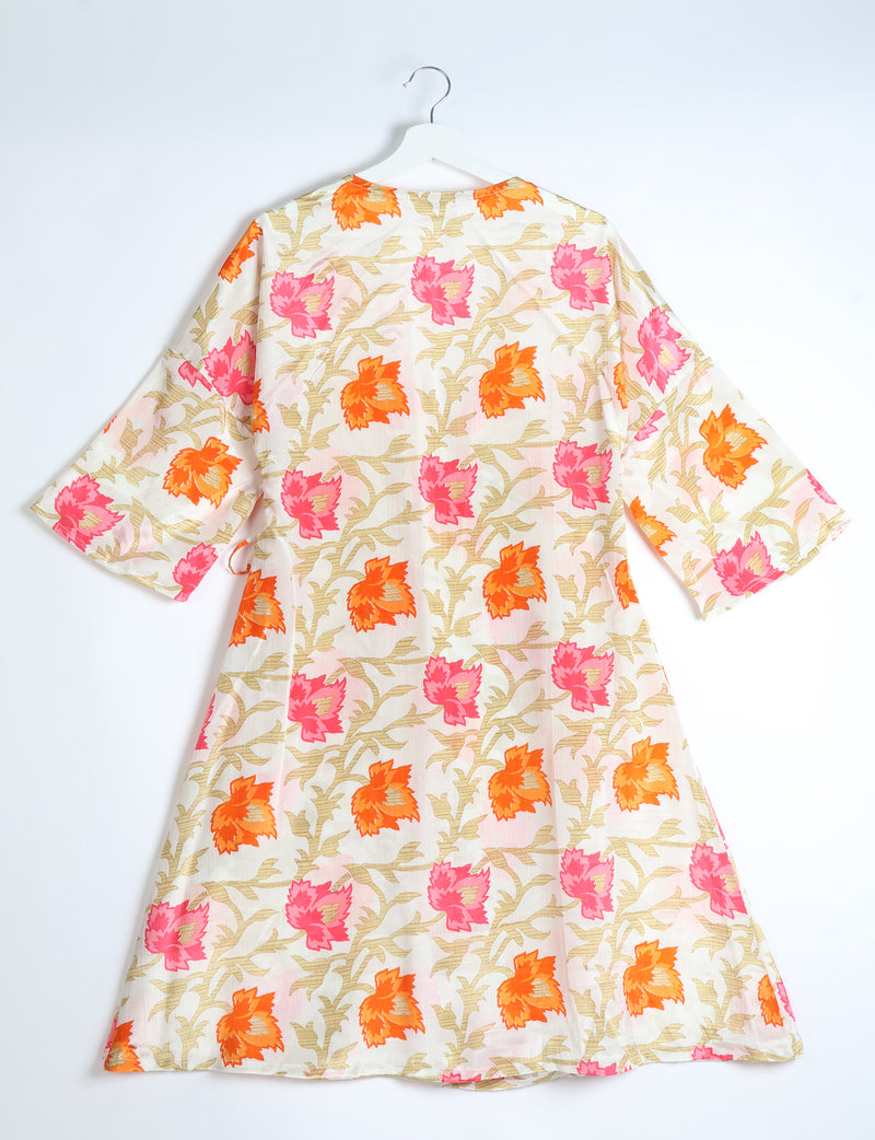White coat with orange and pink floral leaf pattern, three-quarter sleeves, shown from back on white hanger