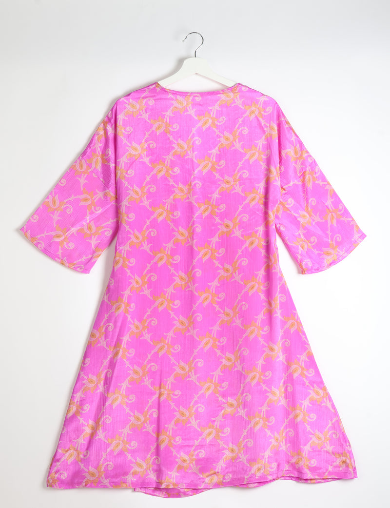 Pink coat with orange floral pattern, wide sleeves, and round neckline, shown from back on white hanger against white