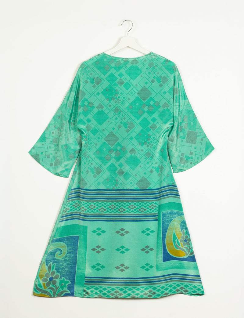 Green geometric patterned coat with wide sleeves hanging on white hanger, back view, featuring blue and yellow border designs