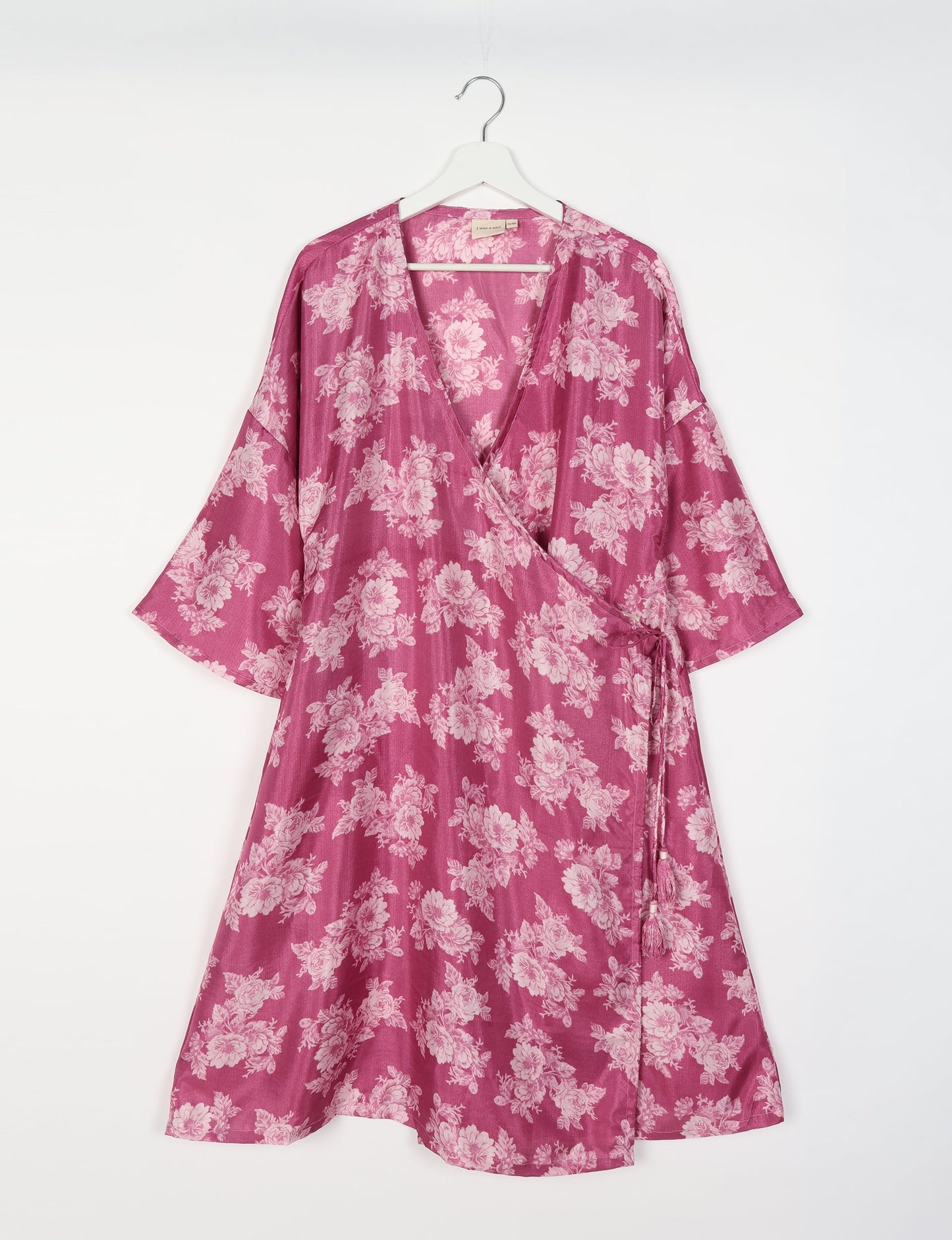 Elevate your style with our Sunset Coat, a shin-length wrap featuring a deep V-neck, wide flared 3/4 sleeves, and side tie with thread tassels. Embrace ethical and sustainable fashion with this zero waste, upcycled garment. A perfect blend of elegance and whimsy for conscious clothing enthusiasts.