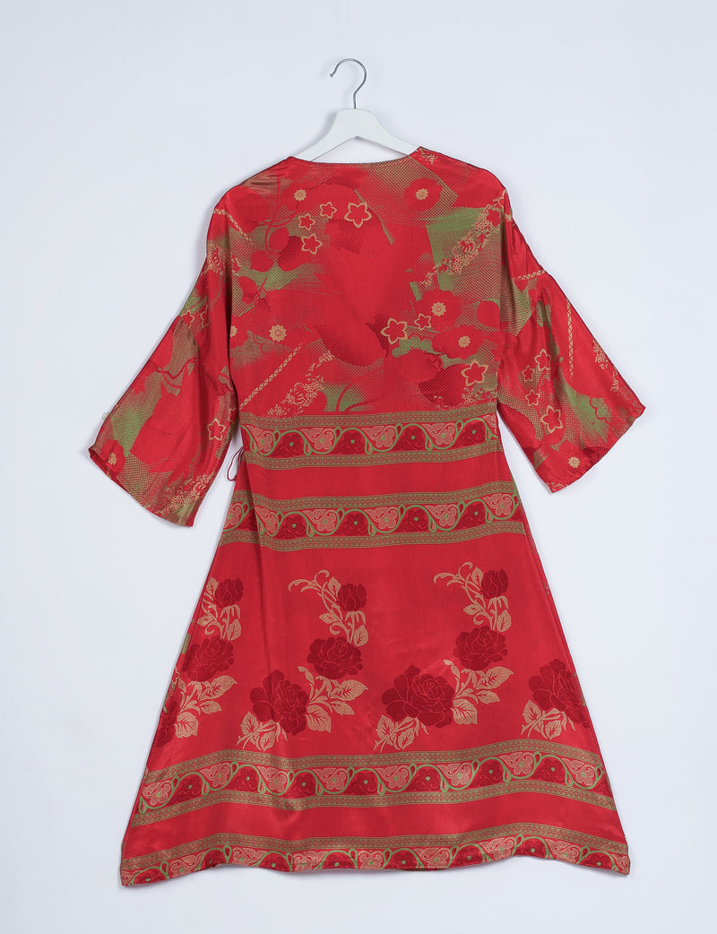 Red coat with abstract floral and geometric patterns in gold and green, shown from back on white hanger against white background