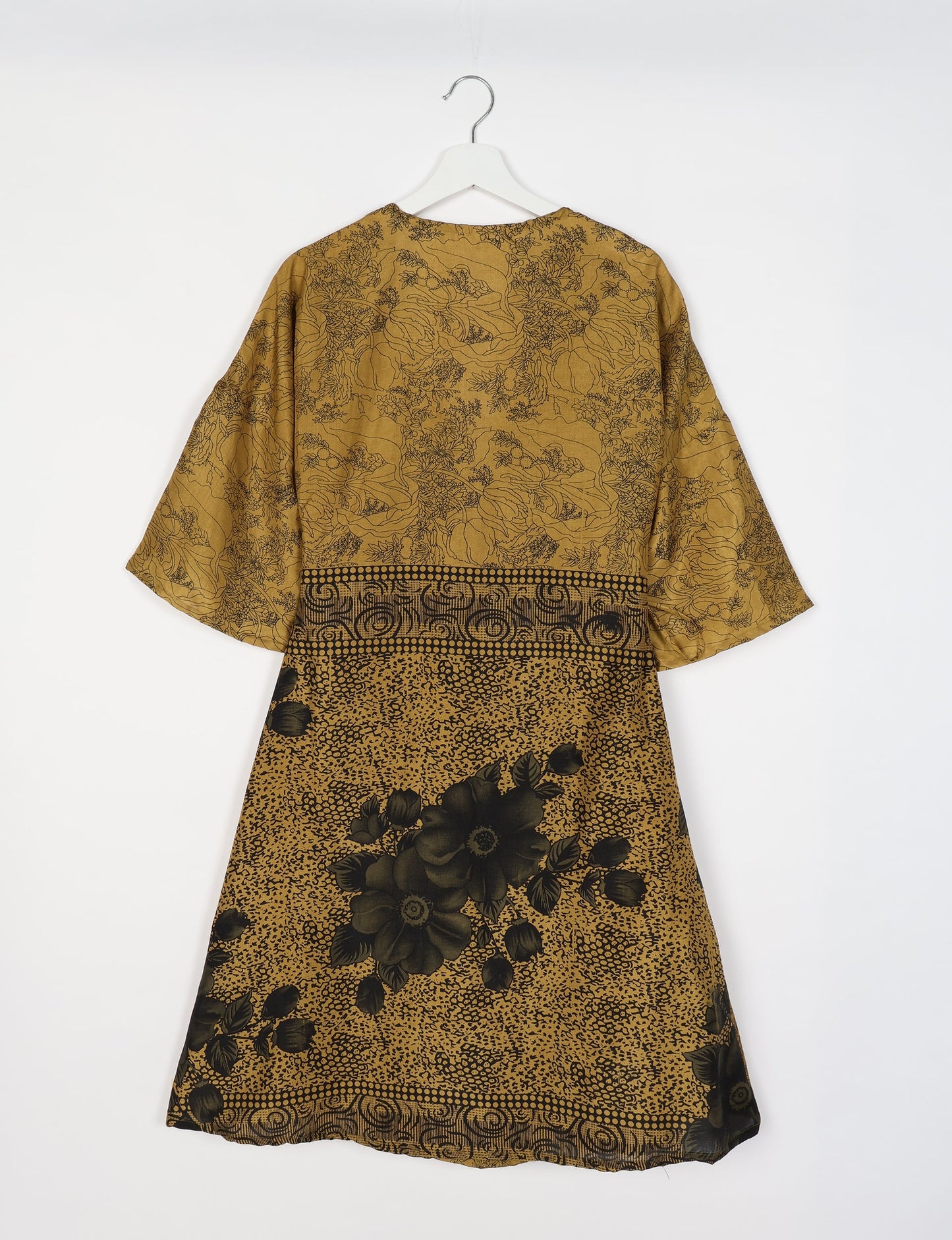 Elevate your style with our Sunset Coat, a shin-length wrap featuring a deep V-neck, wide flared 3/4 sleeves, and side tie with thread tassels. Embrace ethical and sustainable fashion with this zero waste, upcycled garment. A perfect blend of elegance and whimsy for conscious clothing enthusiasts.