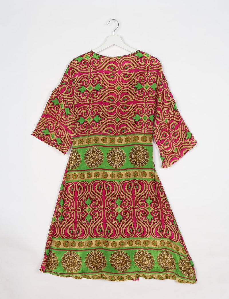 Pink paisley patterned coat with green and gold floral and geometric border, shown from back on white hanger