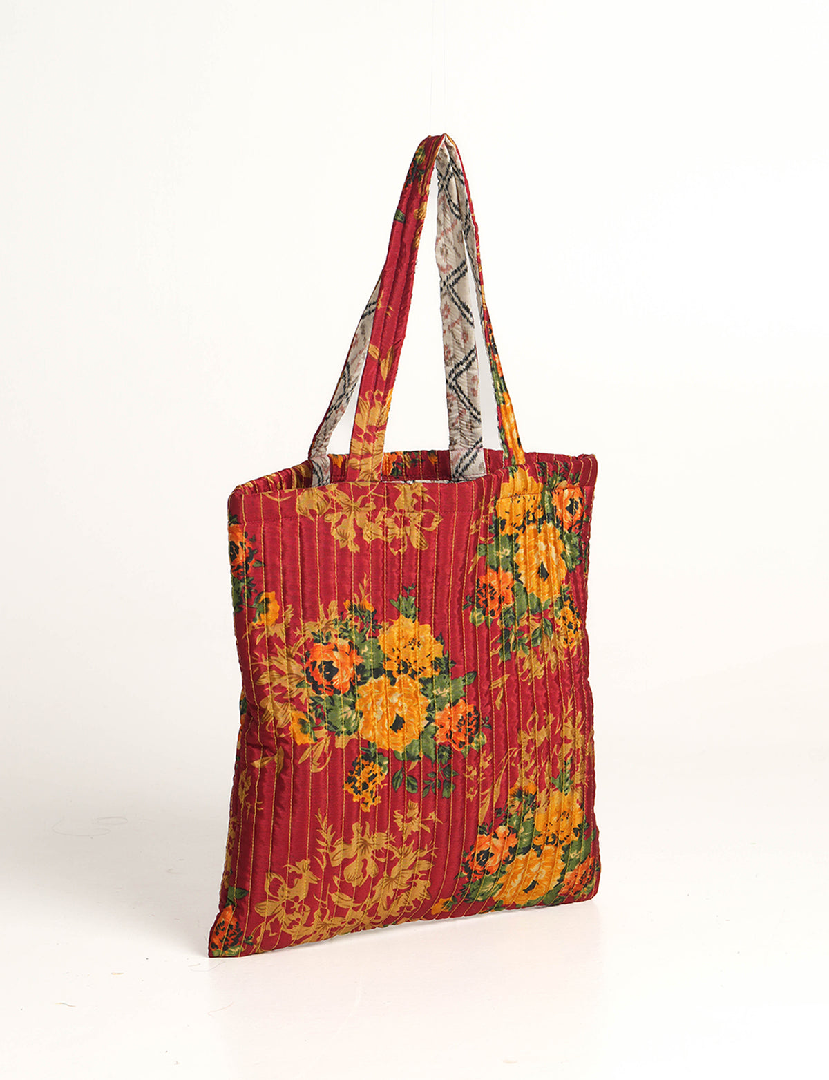 Elevate your style sustainably with our QUILTED SHOPPER BAG. Soft textures, vibrant colors, and a positive impact on people and the planet. Perfect for the office, shopping, or happy hour. Crafted from pre-loved saris for eco-conscious fashionistas!