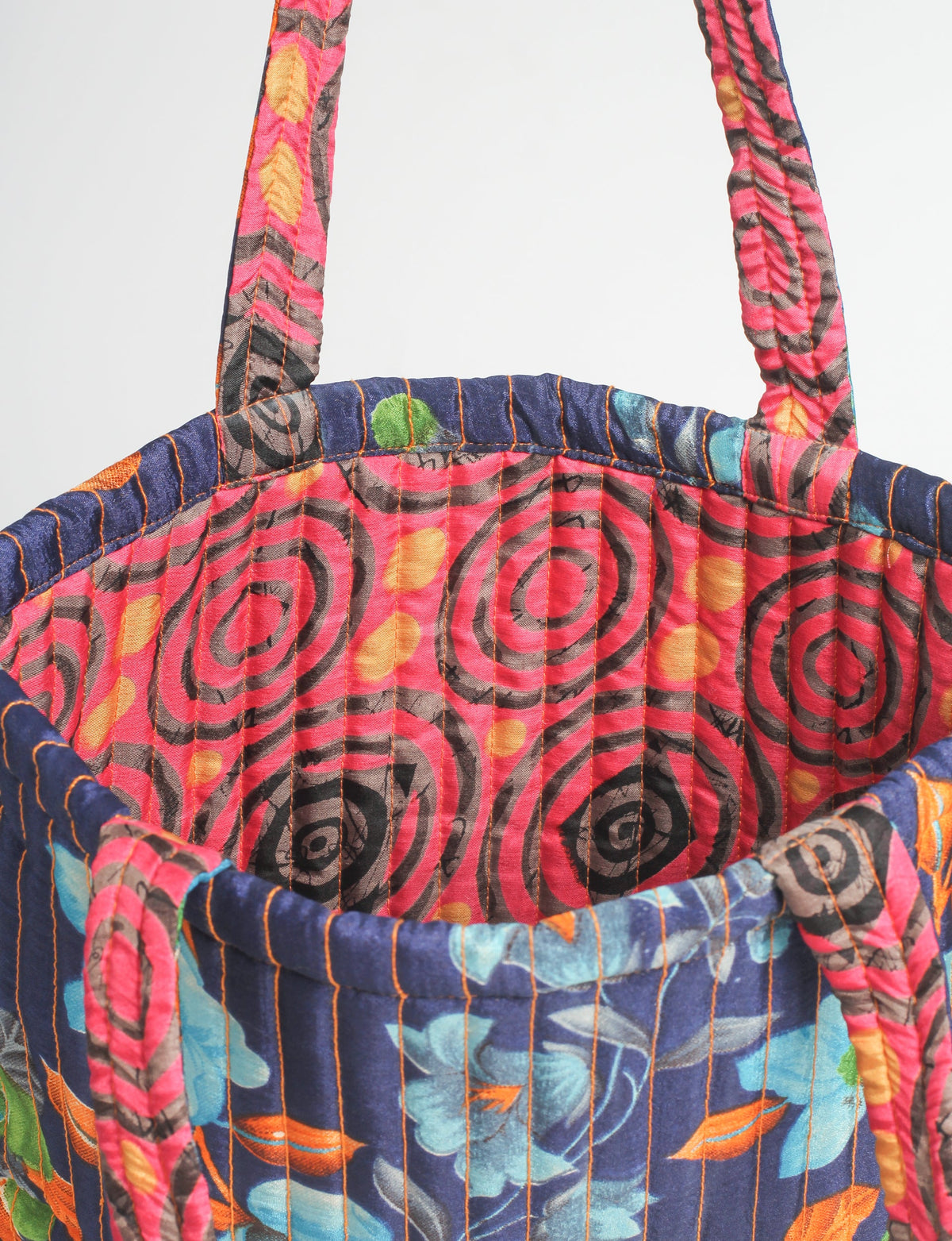 Elevate your style sustainably with our QUILTED SHOPPER BAG. Soft textures, vibrant colors, and a positive impact on people and the planet. Perfect for the office, shopping, or happy hour. Crafted from pre-loved saris for eco-conscious fashionistas!