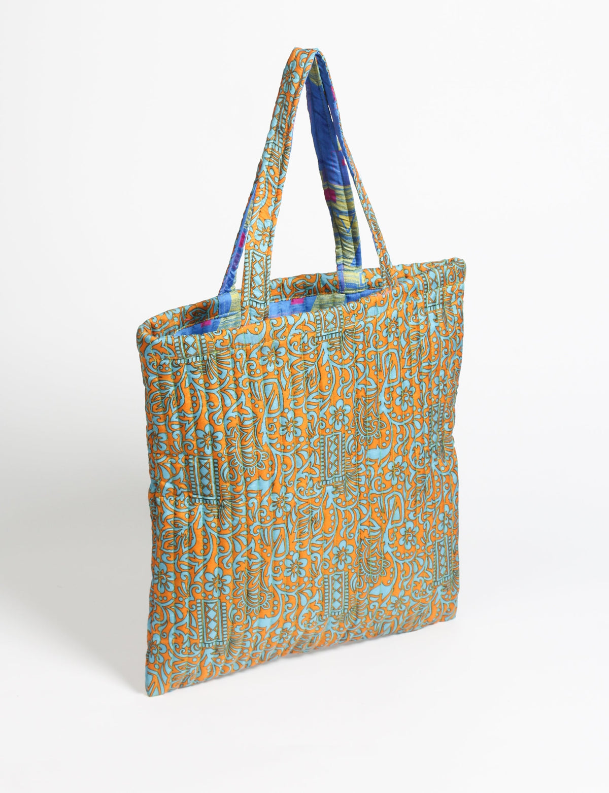 Elevate your style sustainably with our QUILTED SHOPPER BAG. Soft textures, vibrant colors, and a positive impact on people and the planet. Perfect for the office, shopping, or happy hour. Crafted from pre-loved saris for eco-conscious fashionistas!