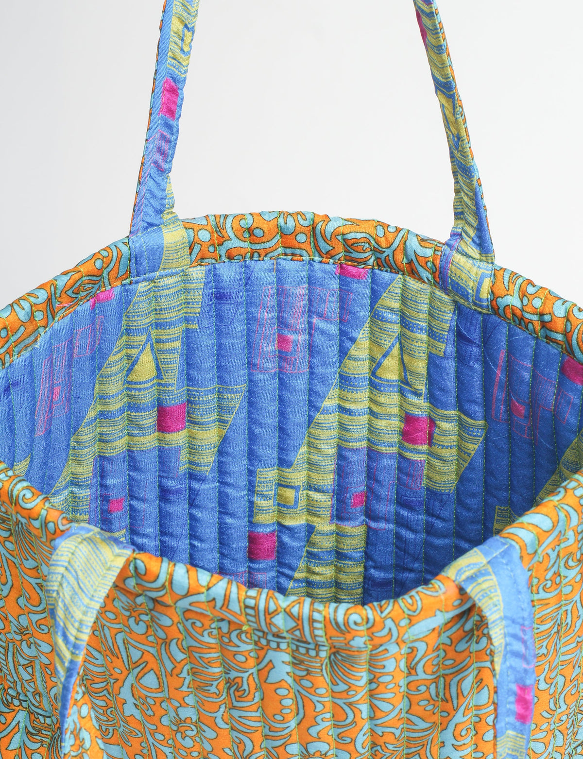 Elevate your style sustainably with our QUILTED SHOPPER BAG. Soft textures, vibrant colors, and a positive impact on people and the planet. Perfect for the office, shopping, or happy hour. Crafted from pre-loved saris for eco-conscious fashionistas!