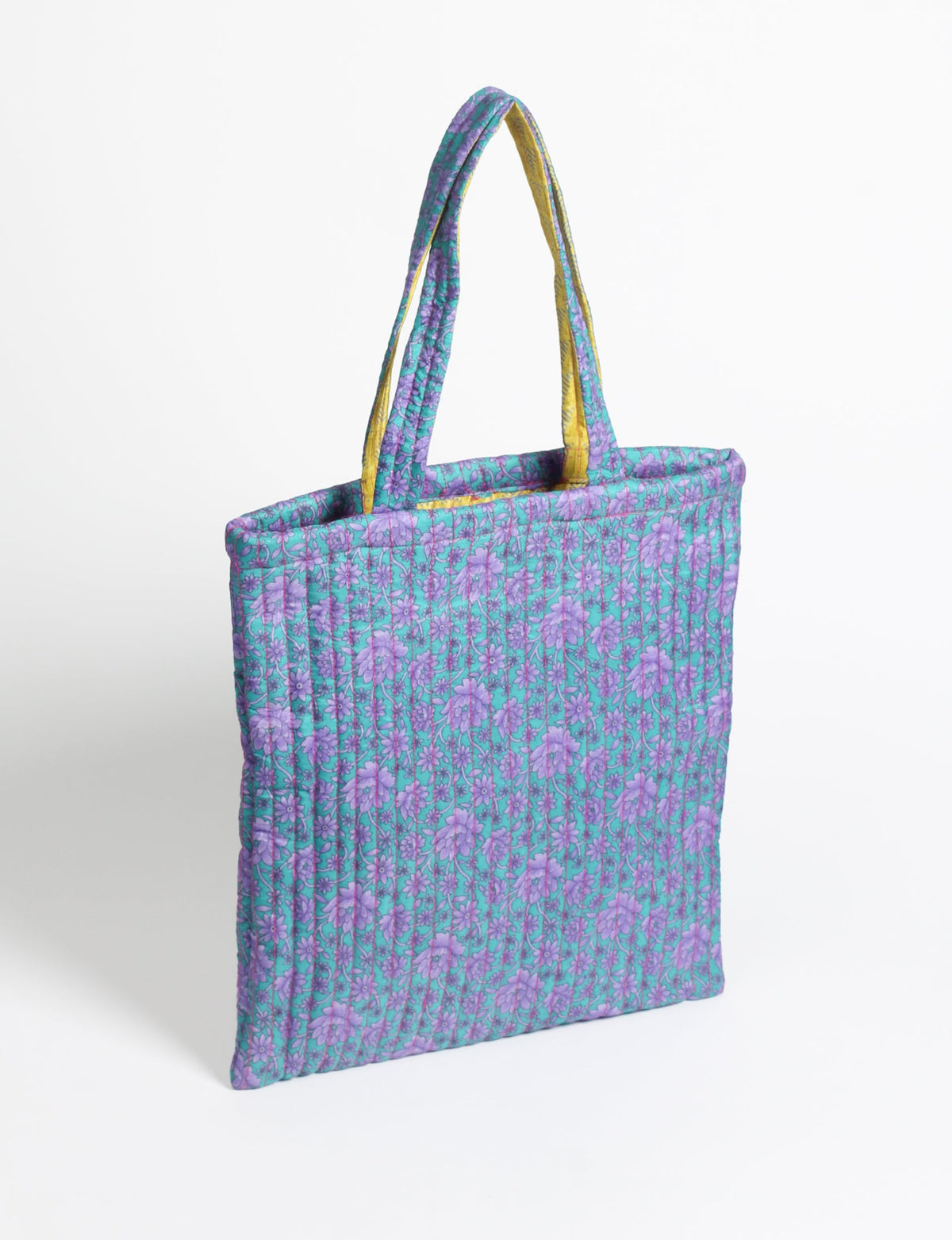 Elevate your style sustainably with our QUILTED SHOPPER BAG. Soft textures, vibrant colors, and a positive impact on people and the planet. Perfect for the office, shopping, or happy hour. Crafted from pre-loved saris for eco-conscious fashionistas!