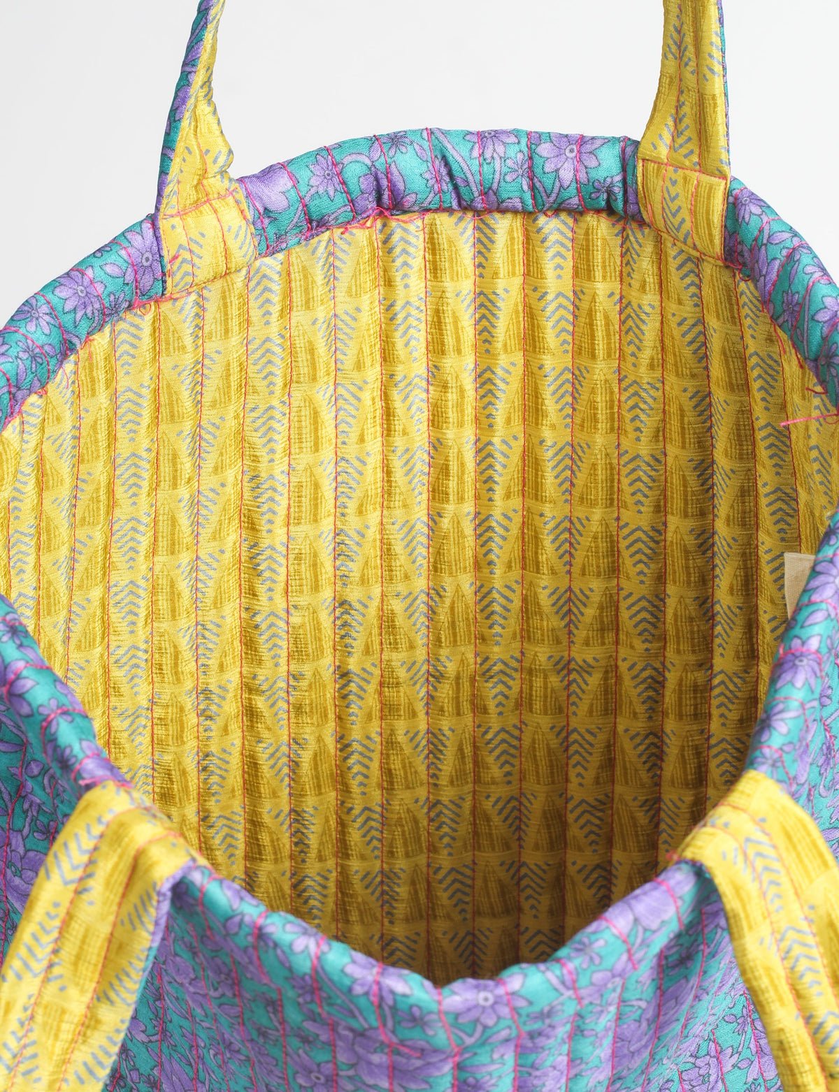 Elevate your style sustainably with our QUILTED SHOPPER BAG. Soft textures, vibrant colors, and a positive impact on people and the planet. Perfect for the office, shopping, or happy hour. Crafted from pre-loved saris for eco-conscious fashionistas!