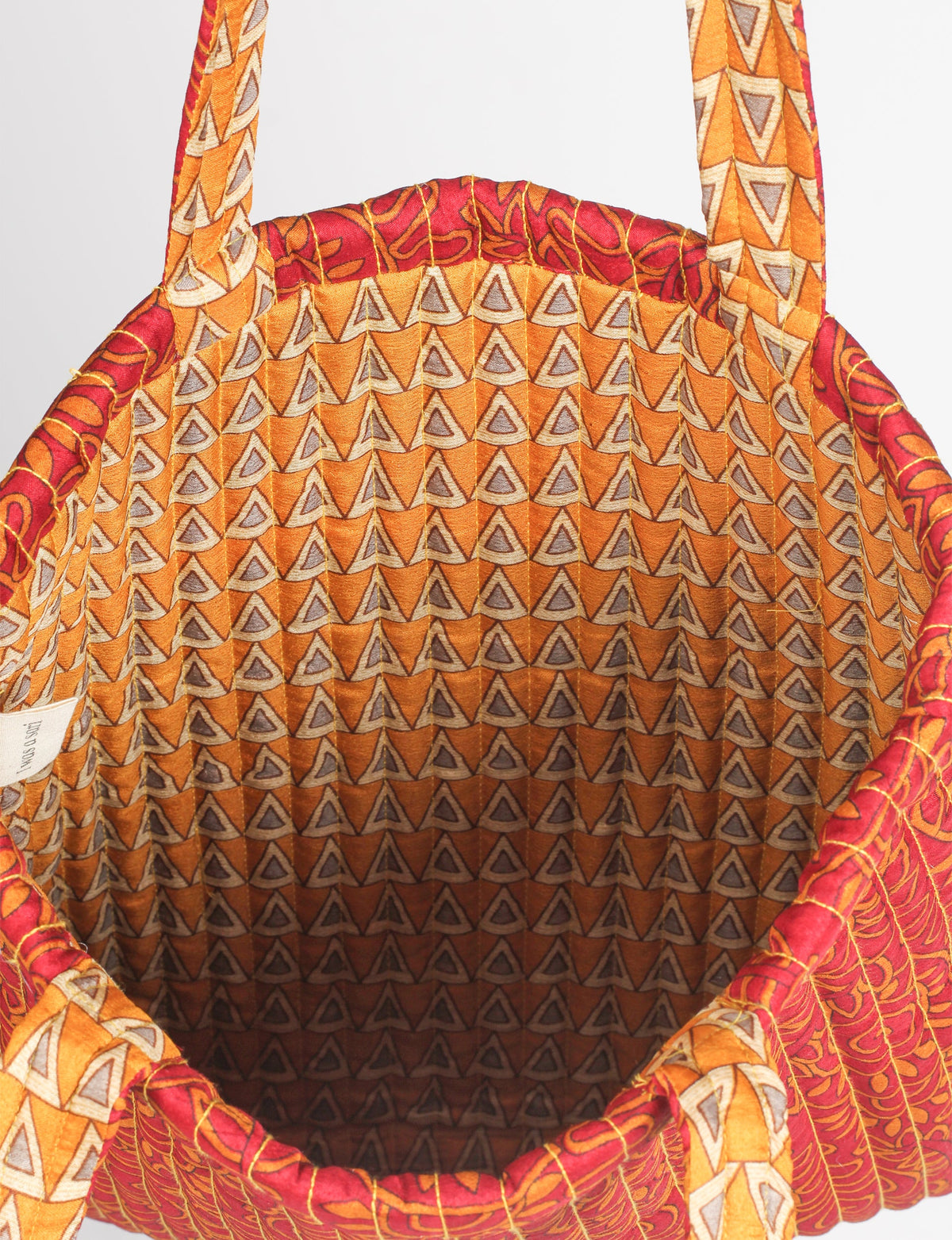 Elevate your style sustainably with our QUILTED SHOPPER BAG. Soft textures, vibrant colors, and a positive impact on people and the planet. Perfect for the office, shopping, or happy hour. Crafted from pre-loved saris for eco-conscious fashionistas!
