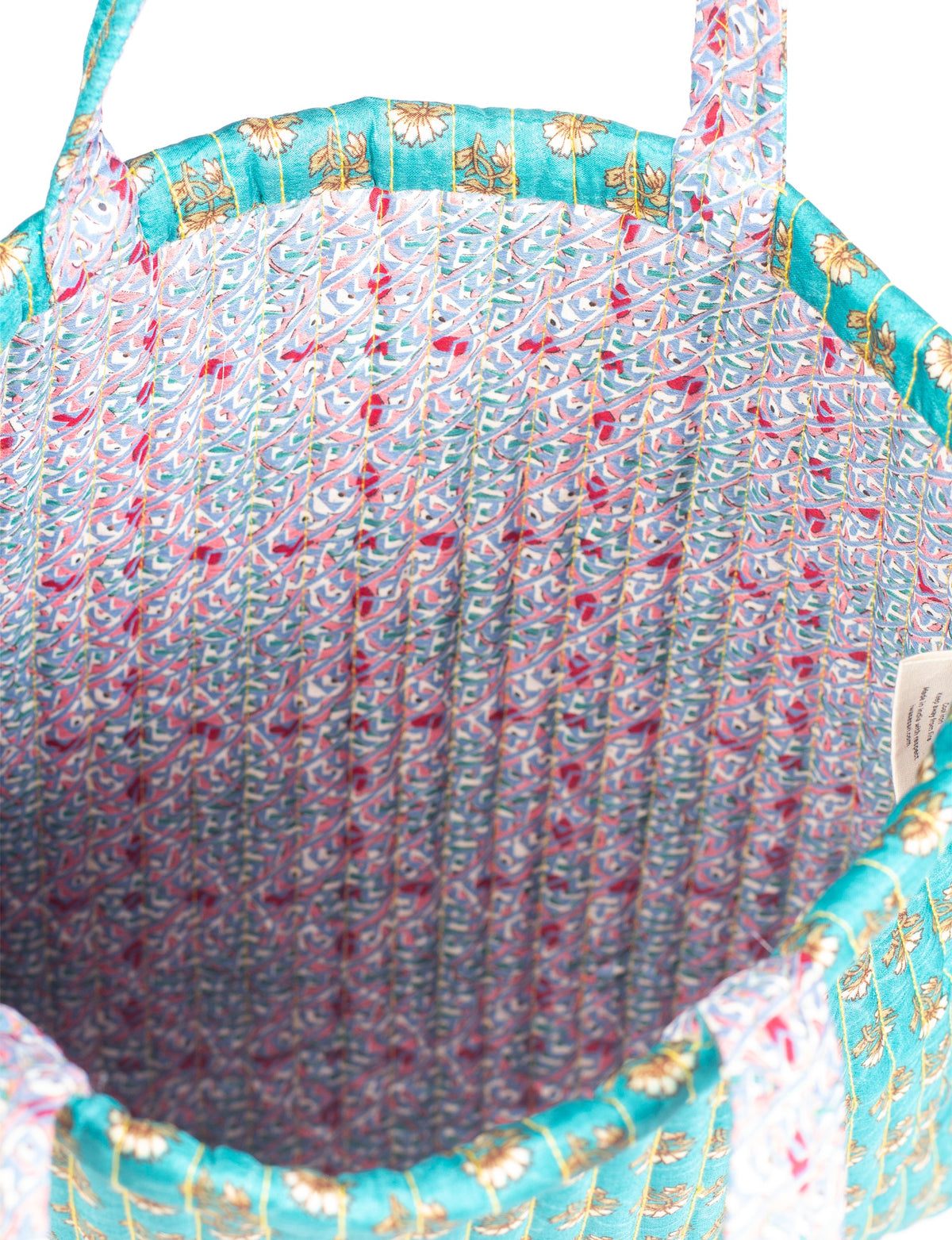 Elevate your style sustainably with our QUILTED SHOPPER BAG. Soft textures, vibrant colors, and a positive impact on people and the planet. Perfect for the office, shopping, or happy hour. Crafted from pre-loved saris for eco-conscious fashionistas!