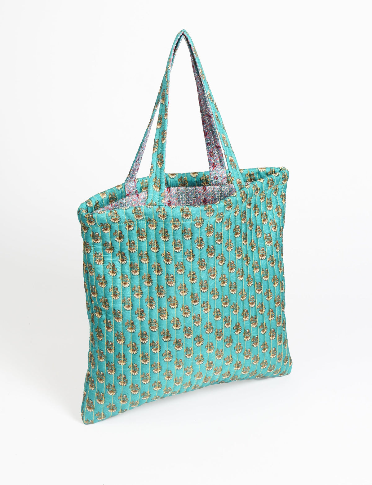 Elevate your style sustainably with our QUILTED SHOPPER BAG. Soft textures, vibrant colors, and a positive impact on people and the planet. Perfect for the office, shopping, or happy hour. Crafted from pre-loved saris for eco-conscious fashionistas!