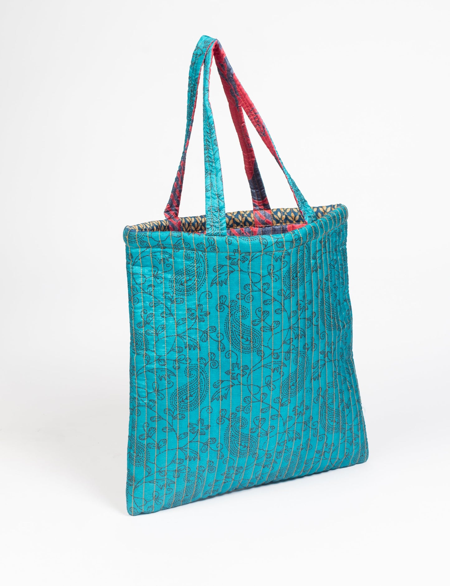 Elevate your style sustainably with our QUILTED SHOPPER BAG. Soft textures, vibrant colors, and a positive impact on people and the planet. Perfect for the office, shopping, or happy hour. Crafted from pre-loved saris for eco-conscious fashionistas!