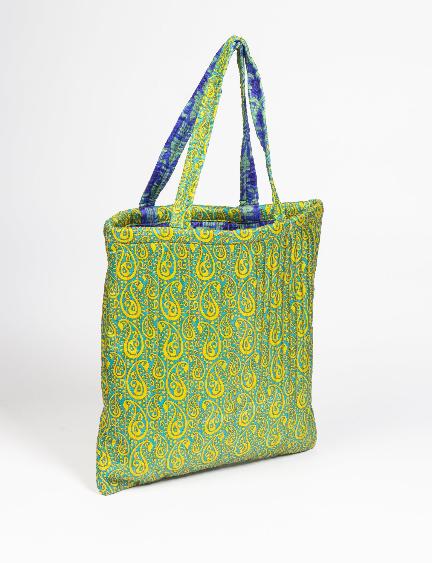 Elevate your style sustainably with our QUILTED SHOPPER BAG. Soft textures, vibrant colors, and a positive impact on people and the planet. Perfect for the office, shopping, or happy hour. Crafted from pre-loved saris for eco-conscious fashionistas!