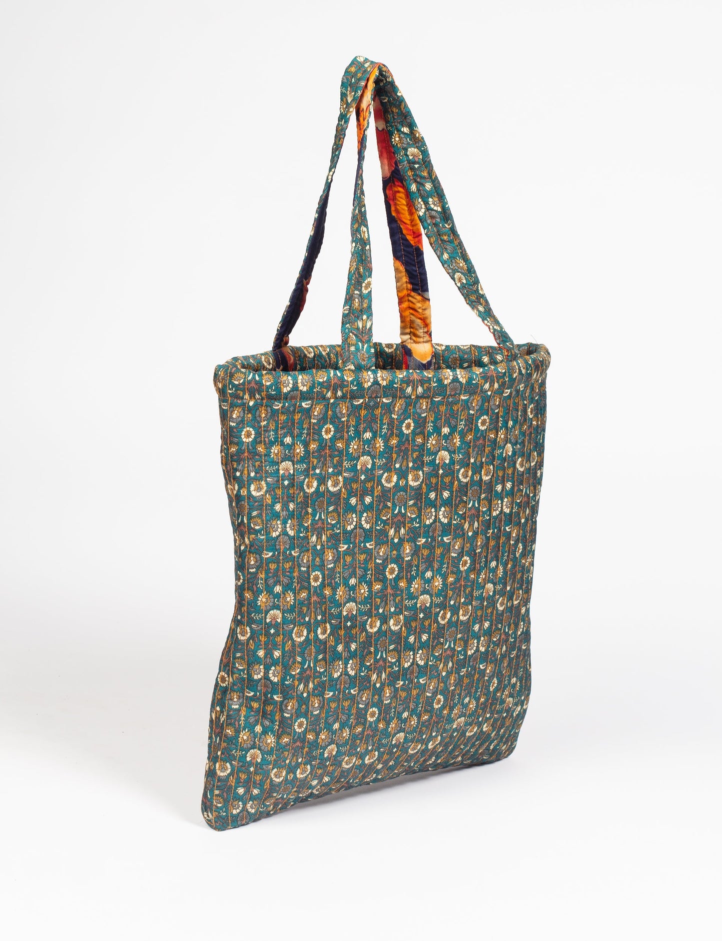 Elevate your style sustainably with our QUILTED SHOPPER BAG. Soft textures, vibrant colors, and a positive impact on people and the planet. Perfect for the office, shopping, or happy hour. Crafted from pre-loved saris for eco-conscious fashionistas!