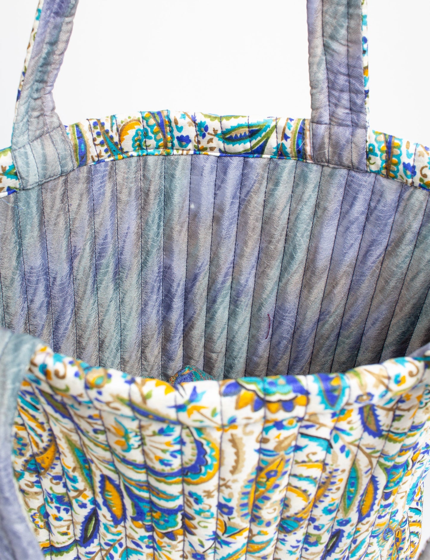 Elevate your style sustainably with our QUILTED SHOPPER BAG. Soft textures, vibrant colors, and a positive impact on people and the planet. Perfect for the office, shopping, or happy hour. Crafted from pre-loved saris for eco-conscious fashionistas!