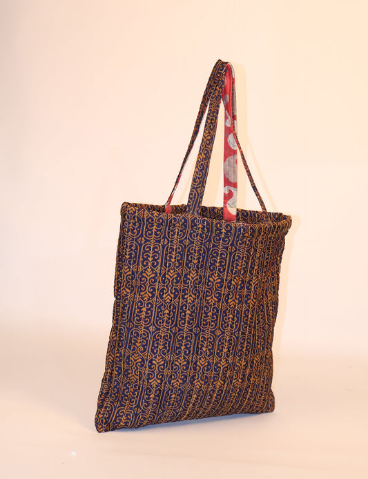 Elevate your style sustainably with our QUILTED SHOPPER BAG. Soft textures, vibrant colors, and a positive impact on people and the planet. Perfect for the office, shopping, or happy hour. Crafted from pre-loved saris for eco-conscious fashionistas!