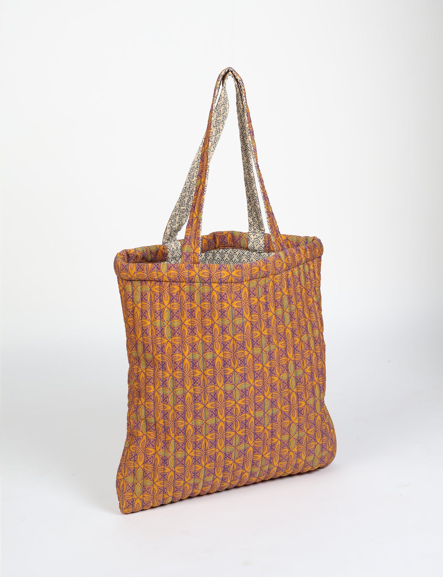 Elevate your style sustainably with our QUILTED SHOPPER BAG. Soft textures, vibrant colors, and a positive impact on people and the planet. Perfect for the office, shopping, or happy hour. Crafted from pre-loved saris for eco-conscious fashionistas!