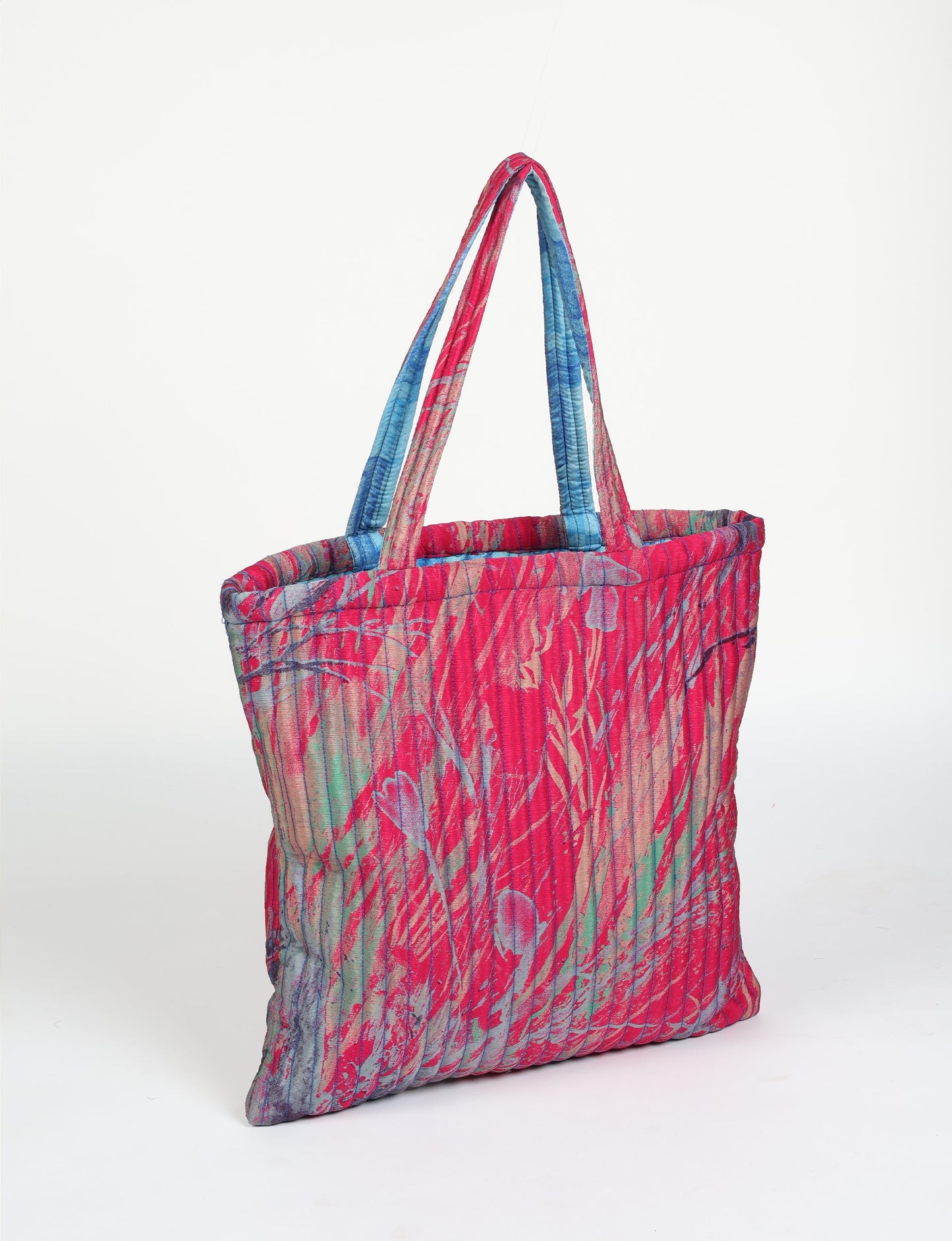 Elevate your style sustainably with our QUILTED SHOPPER BAG. Soft textures, vibrant colors, and a positive impact on people and the planet. Perfect for the office, shopping, or happy hour. Crafted from pre-loved saris for eco-conscious fashionistas!