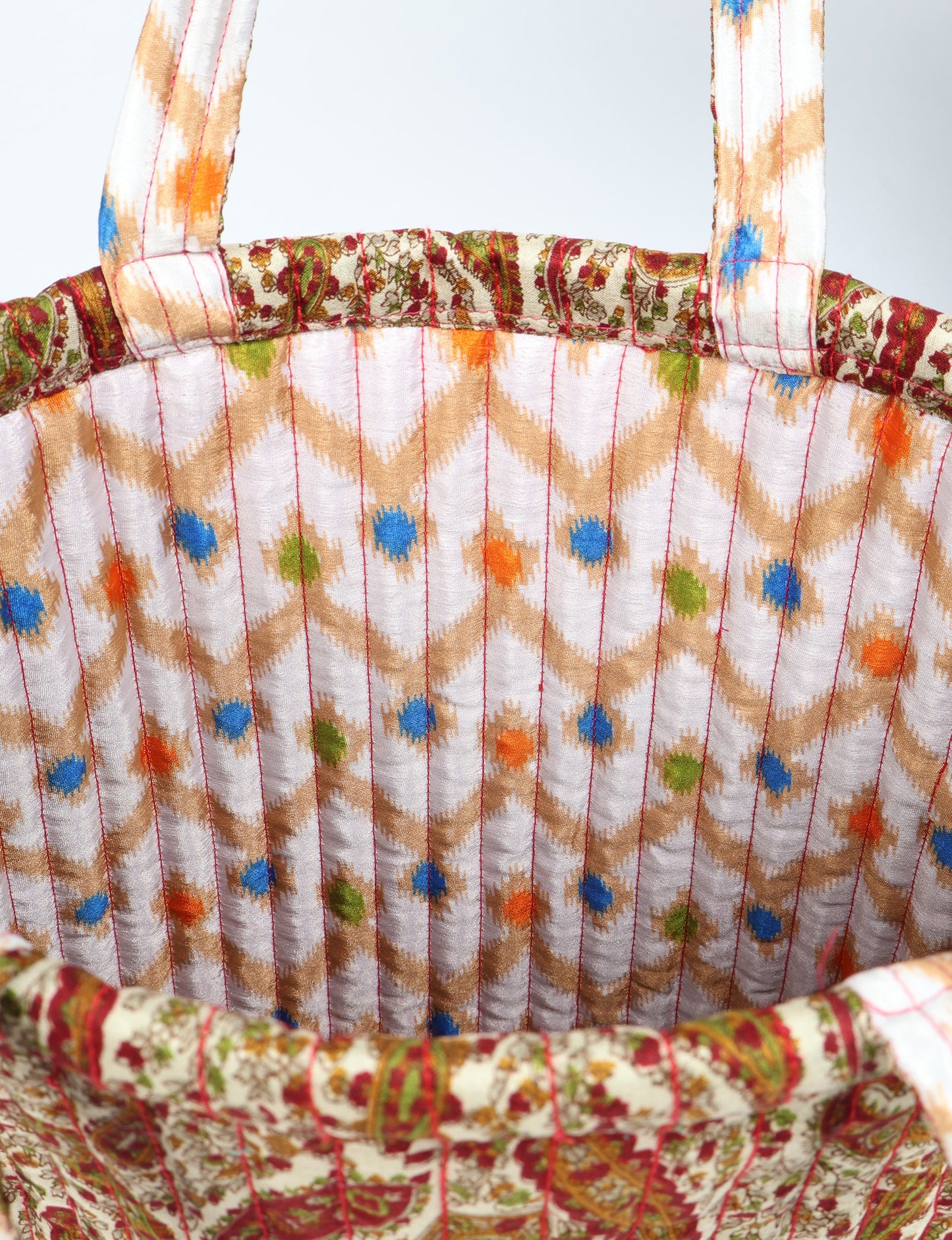 Elevate your style sustainably with our QUILTED SHOPPER BAG. Soft textures, vibrant colors, and a positive impact on people and the planet. Perfect for the office, shopping, or happy hour. Crafted from pre-loved saris for eco-conscious fashionistas!