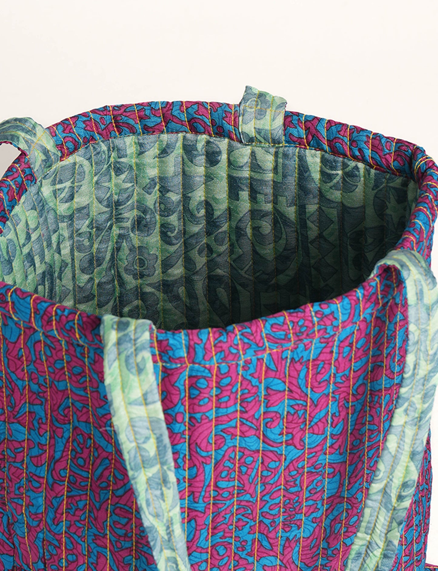 Elevate your style sustainably with our QUILTED SHOPPER BAG. Soft textures, vibrant colors, and a positive impact on people and the planet. Perfect for the office, shopping, or happy hour. Crafted from pre-loved saris for eco-conscious fashionistas!