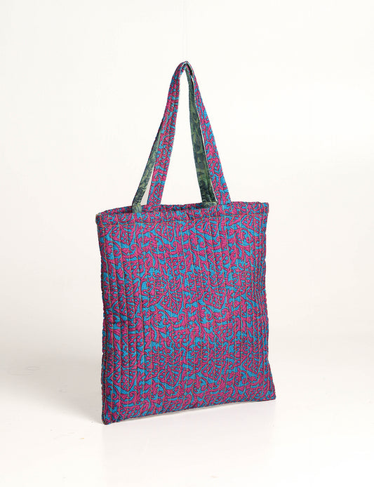 Elevate your style sustainably with our QUILTED SHOPPER BAG. Soft textures, vibrant colors, and a positive impact on people and the planet. Perfect for the office, shopping, or happy hour. Crafted from pre-loved saris for eco-conscious fashionistas!