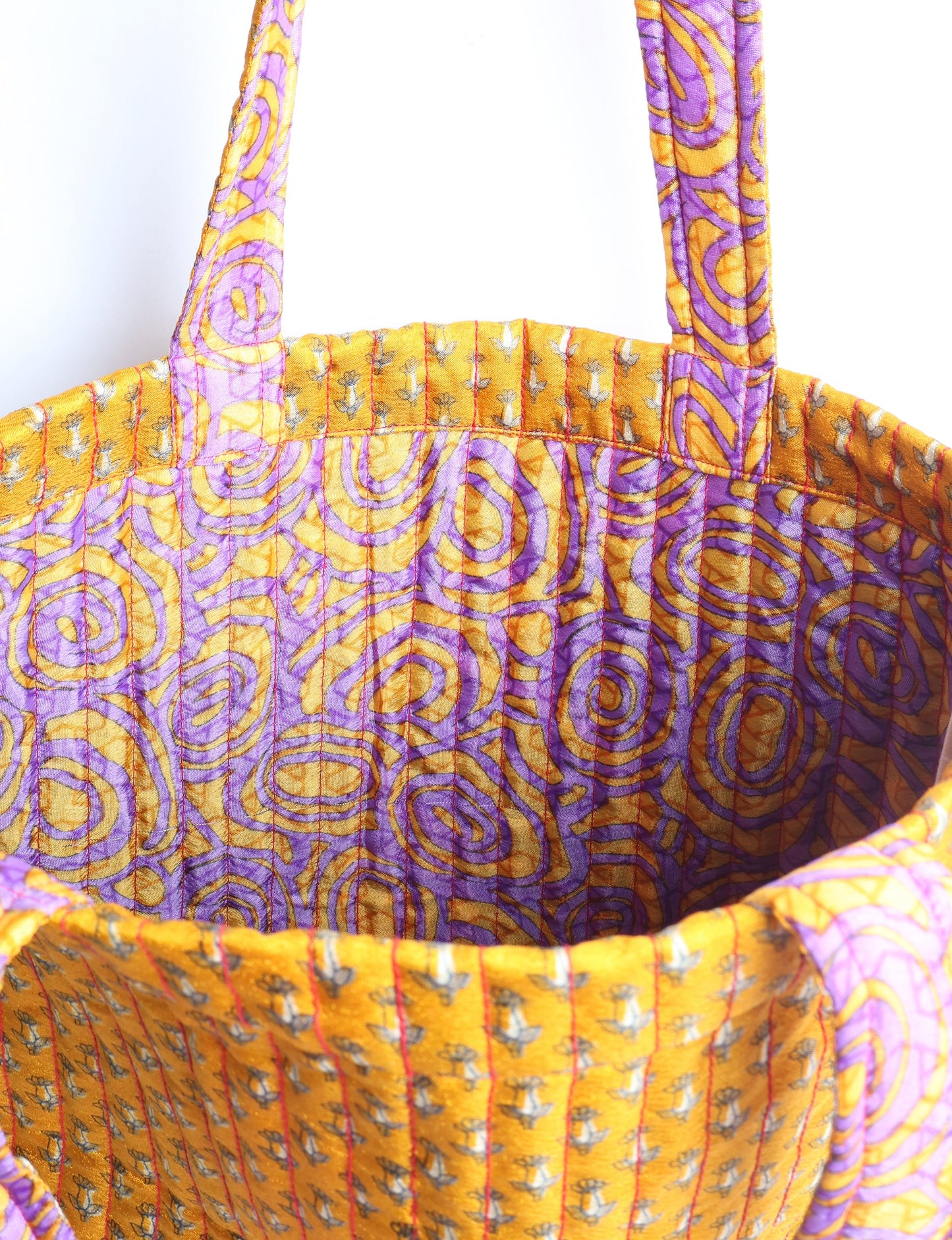 Elevate your style sustainably with our QUILTED SHOPPER BAG. Soft textures, vibrant colors, and a positive impact on people and the planet. Perfect for the office, shopping, or happy hour. Crafted from pre-loved saris for eco-conscious fashionistas!