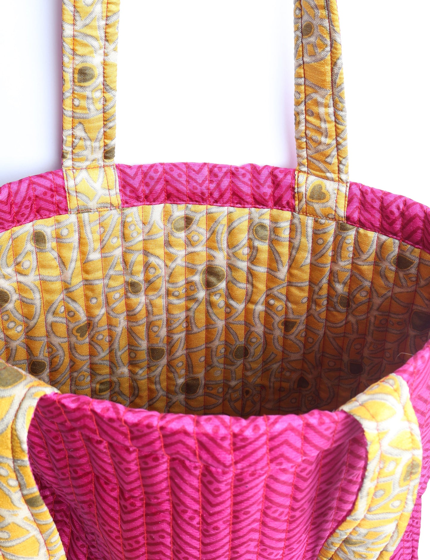 Elevate your style sustainably with our QUILTED SHOPPER BAG. Soft textures, vibrant colors, and a positive impact on people and the planet. Perfect for the office, shopping, or happy hour. Crafted from pre-loved saris for eco-conscious fashionistas!