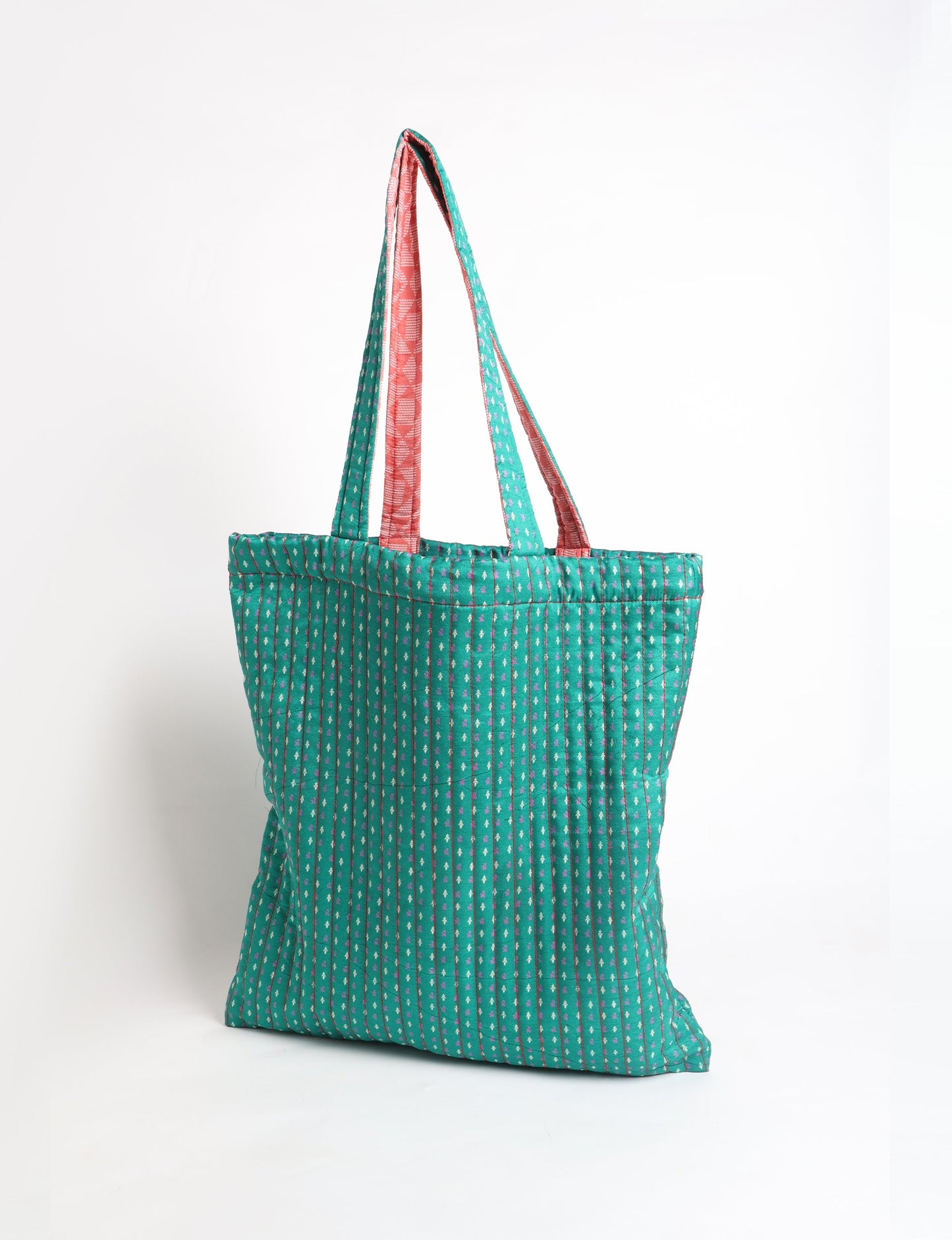 Elevate your style sustainably with our QUILTED SHOPPER BAG. Soft textures, vibrant colors, and a positive impact on people and the planet. Perfect for the office, shopping, or happy hour. Crafted from pre-loved saris for eco-conscious fashionistas!