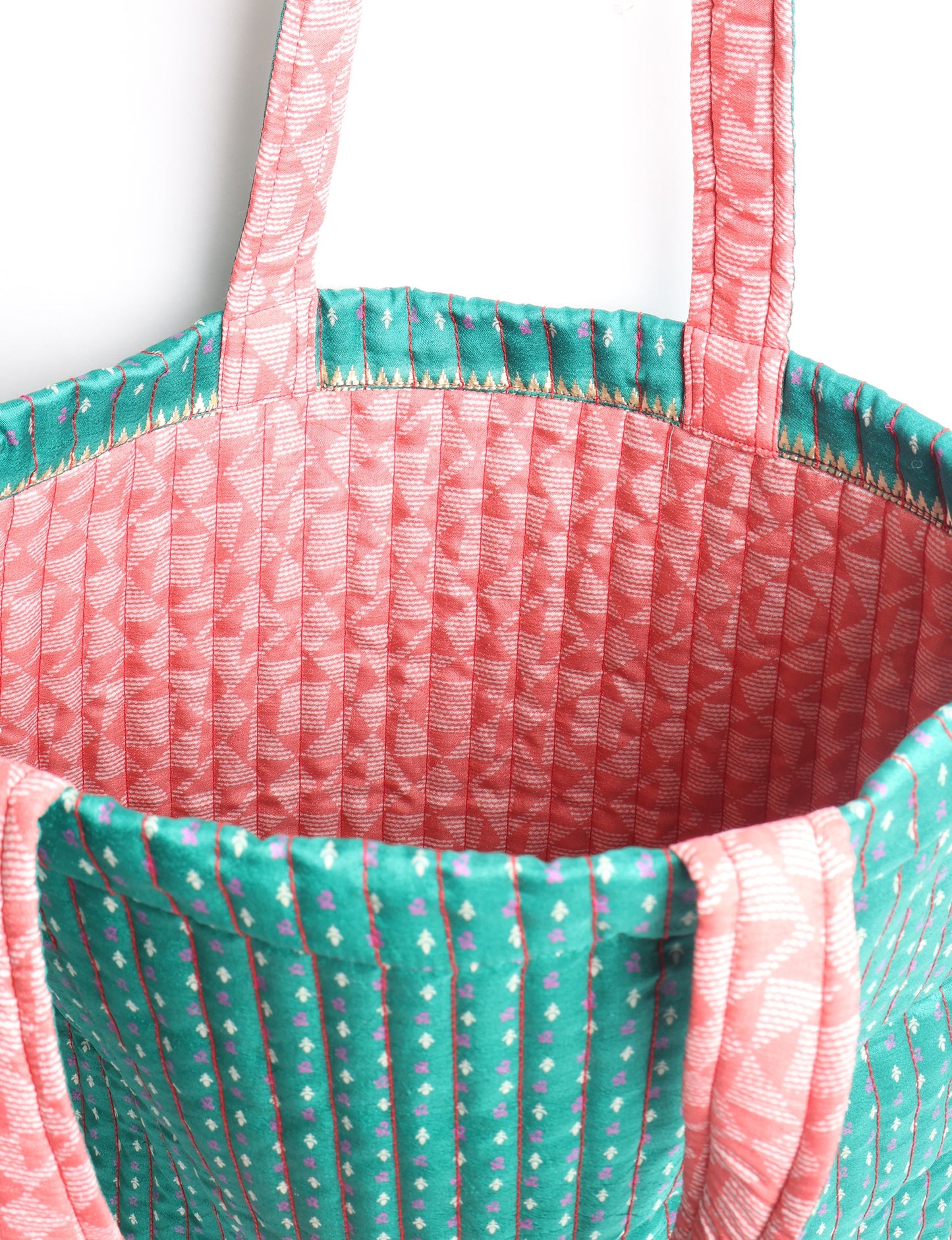 Elevate your style sustainably with our QUILTED SHOPPER BAG. Soft textures, vibrant colors, and a positive impact on people and the planet. Perfect for the office, shopping, or happy hour. Crafted from pre-loved saris for eco-conscious fashionistas!