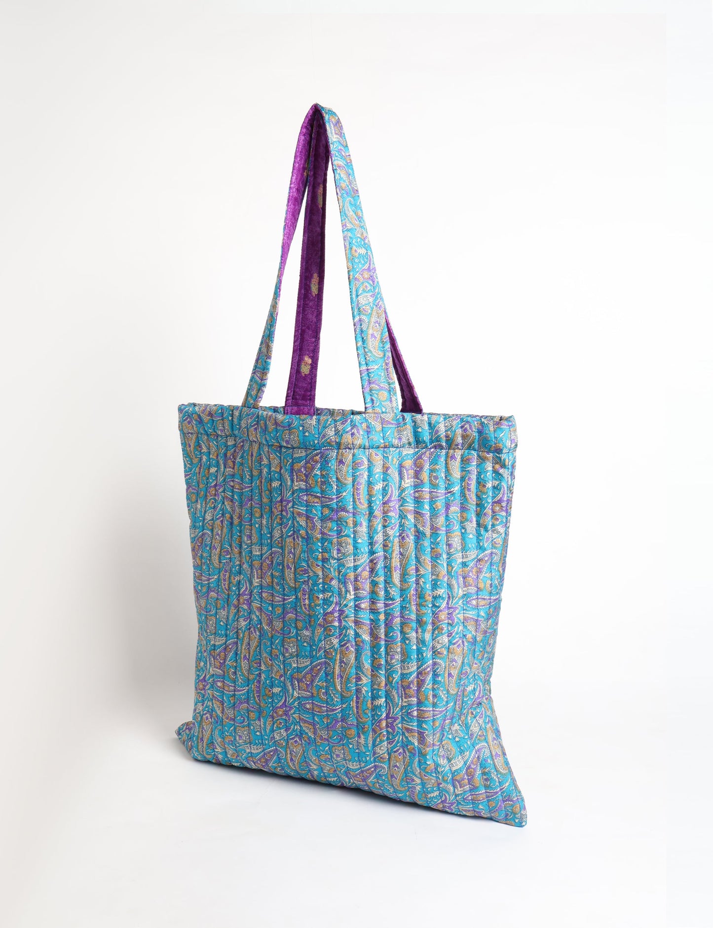 Elevate your style sustainably with our QUILTED SHOPPER BAG. Soft textures, vibrant colors, and a positive impact on people and the planet. Perfect for the office, shopping, or happy hour. Crafted from pre-loved saris for eco-conscious fashionistas!