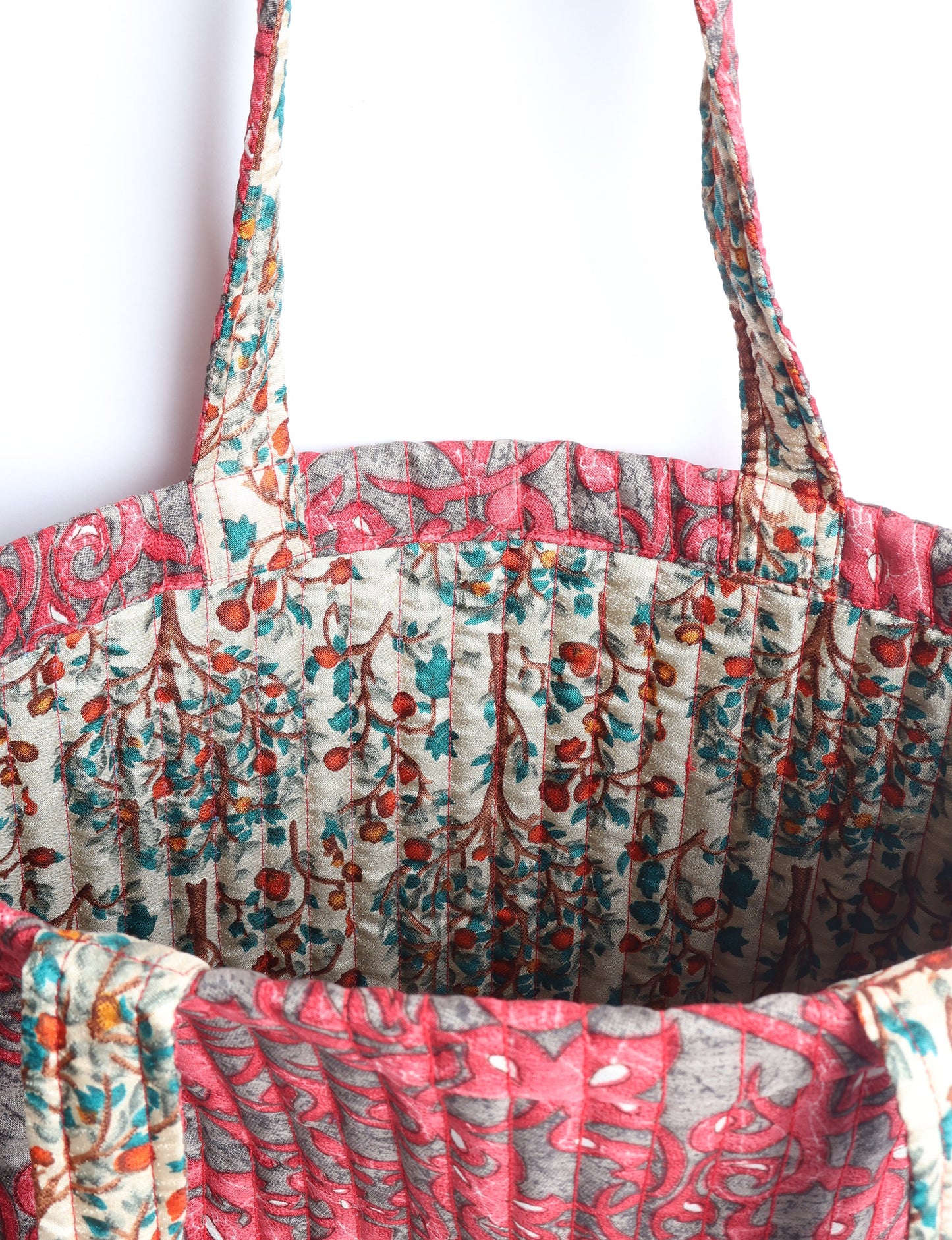 Elevate your style sustainably with our QUILTED SHOPPER BAG. Soft textures, vibrant colors, and a positive impact on people and the planet. Perfect for the office, shopping, or happy hour. Crafted from pre-loved saris for eco-conscious fashionistas!