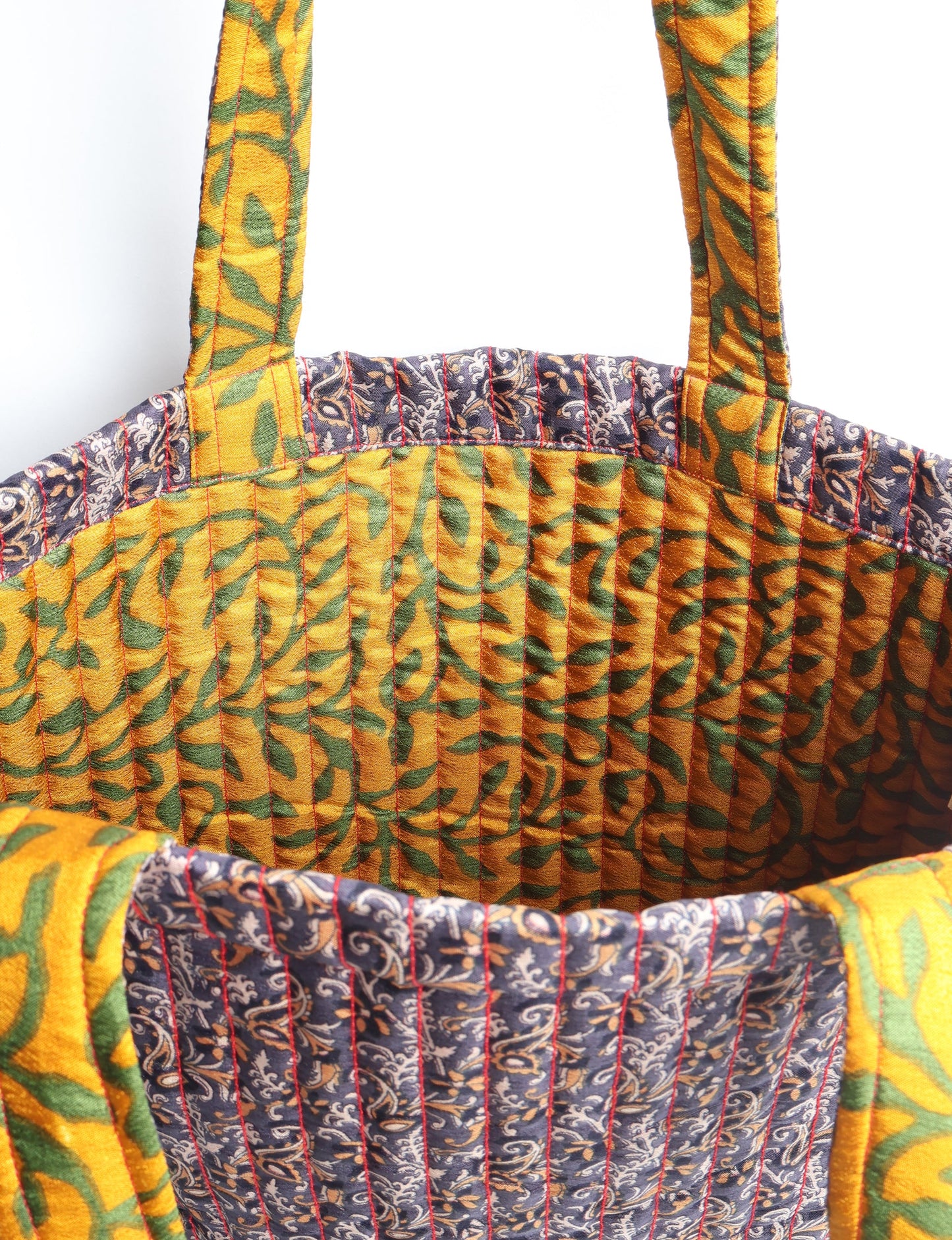 Elevate your style sustainably with our QUILTED SHOPPER BAG. Soft textures, vibrant colors, and a positive impact on people and the planet. Perfect for the office, shopping, or happy hour. Crafted from pre-loved saris for eco-conscious fashionistas!