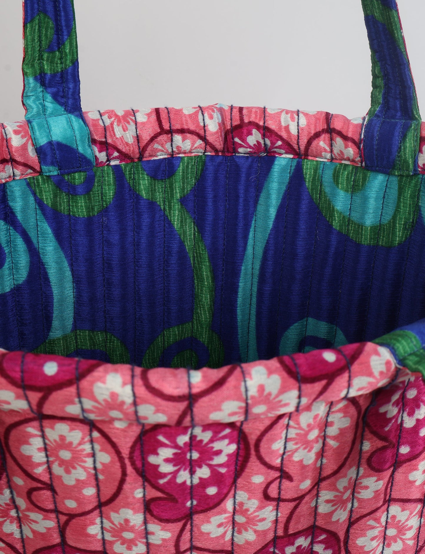 Elevate your style sustainably with our QUILTED SHOPPER BAG. Soft textures, vibrant colors, and a positive impact on people and the planet. Perfect for the office, shopping, or happy hour. Crafted from pre-loved saris for eco-conscious fashionistas!