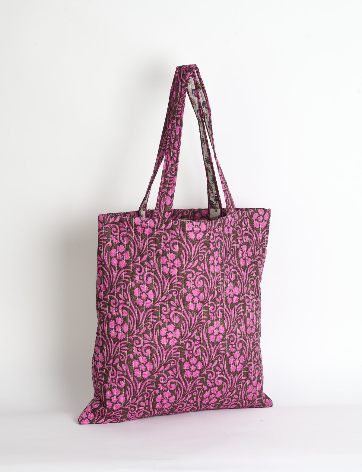Elevate your style sustainably with our QUILTED SHOPPER BAG. Soft textures, vibrant colors, and a positive impact on people and the planet. Perfect for the office, shopping, or happy hour. Crafted from pre-loved saris for eco-conscious fashionistas!