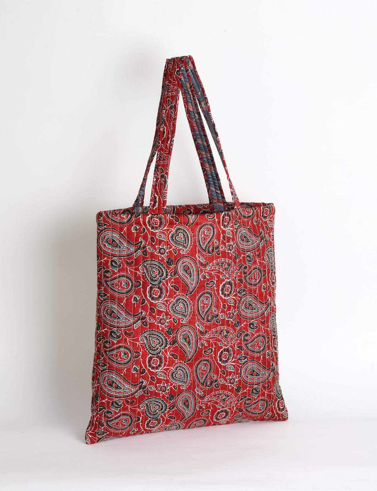 Elevate your style sustainably with our QUILTED SHOPPER BAG. Soft textures, vibrant colors, and a positive impact on people and the planet. Perfect for the office, shopping, or happy hour. Crafted from pre-loved saris for eco-conscious fashionistas!