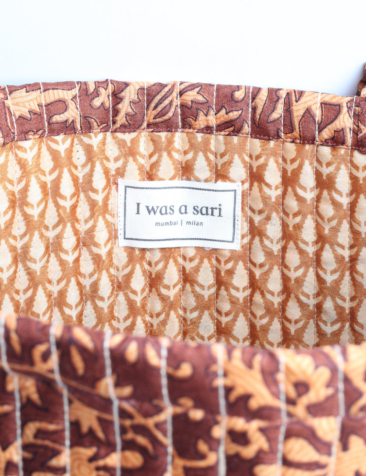 Elevate your style sustainably with our QUILTED SHOPPER BAG. Soft textures, vibrant colors, and a positive impact on people and the planet. Perfect for the office, shopping, or happy hour. Crafted from pre-loved saris for eco-conscious fashionistas!