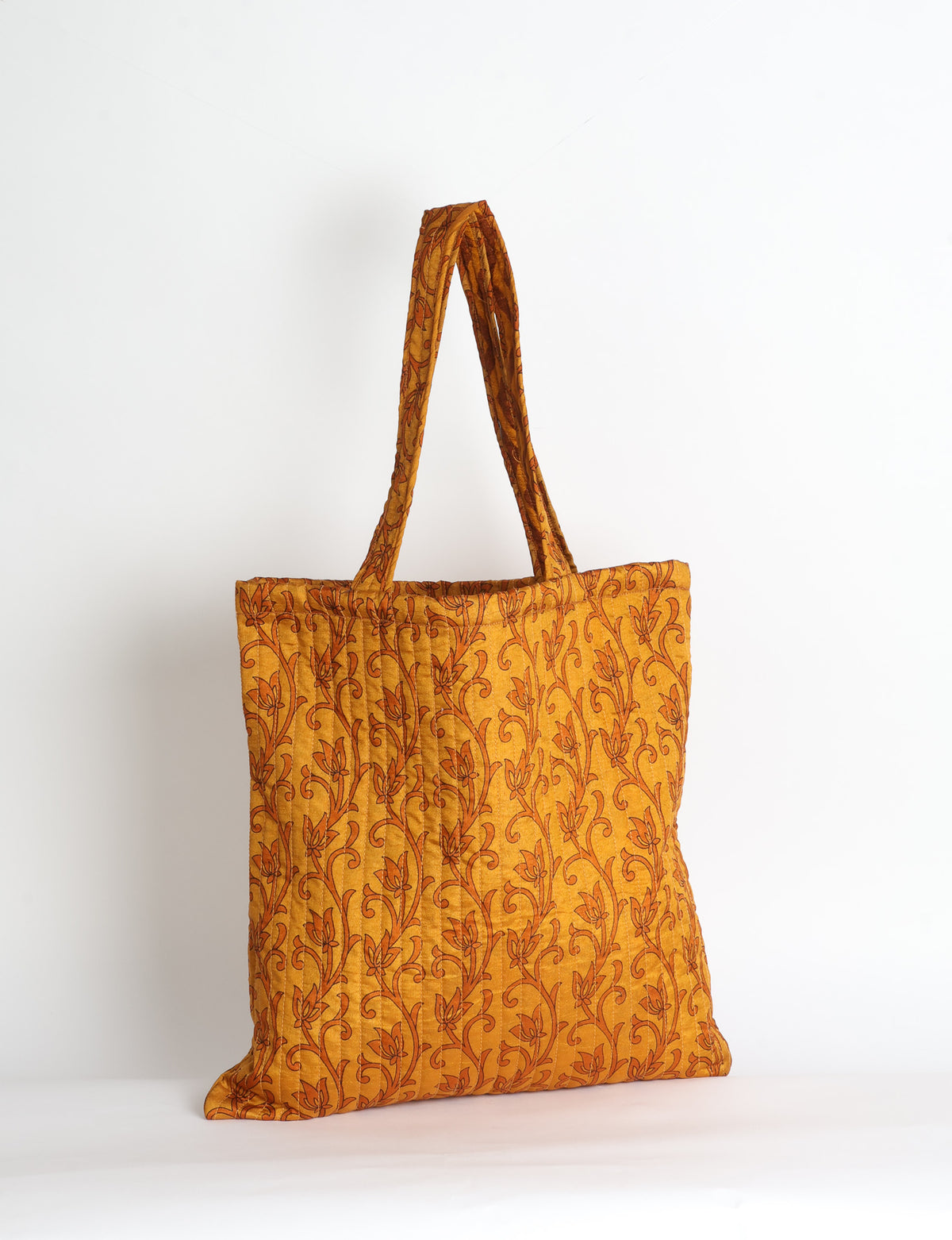 Elevate your style sustainably with our QUILTED SHOPPER BAG. Soft textures, vibrant colors, and a positive impact on people and the planet. Perfect for the office, shopping, or happy hour. Crafted from pre-loved saris for eco-conscious fashionistas!
