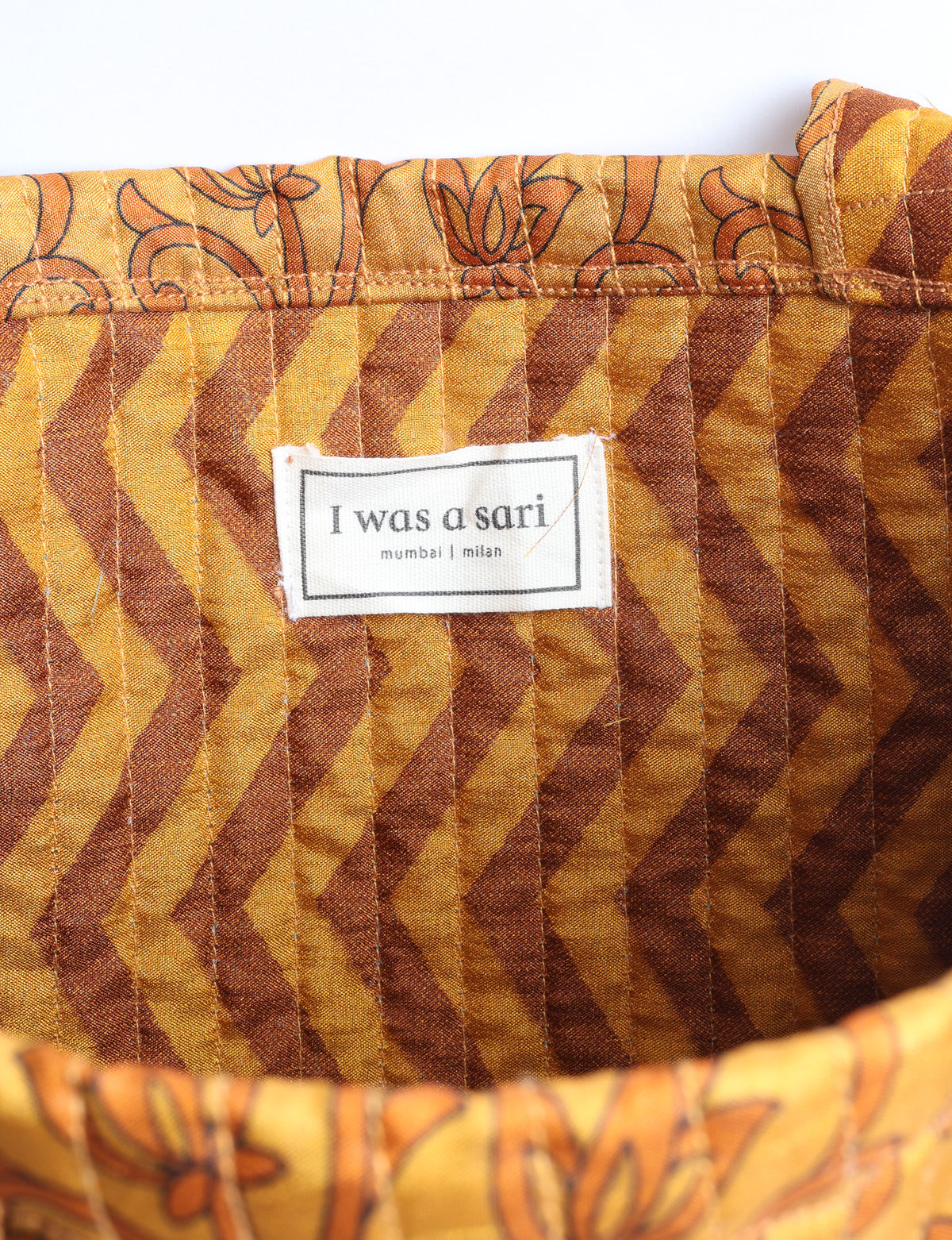 Elevate your style sustainably with our QUILTED SHOPPER BAG. Soft textures, vibrant colors, and a positive impact on people and the planet. Perfect for the office, shopping, or happy hour. Crafted from pre-loved saris for eco-conscious fashionistas!