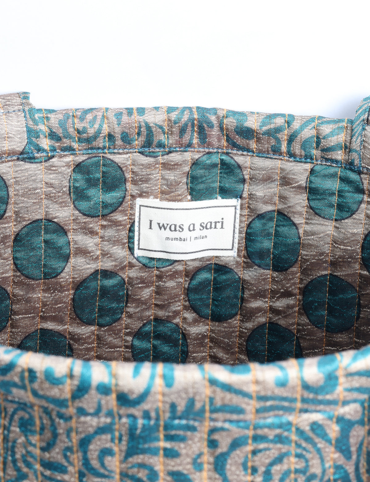 Elevate your style sustainably with our QUILTED SHOPPER BAG. Soft textures, vibrant colors, and a positive impact on people and the planet. Perfect for the office, shopping, or happy hour. Crafted from pre-loved saris for eco-conscious fashionistas!
