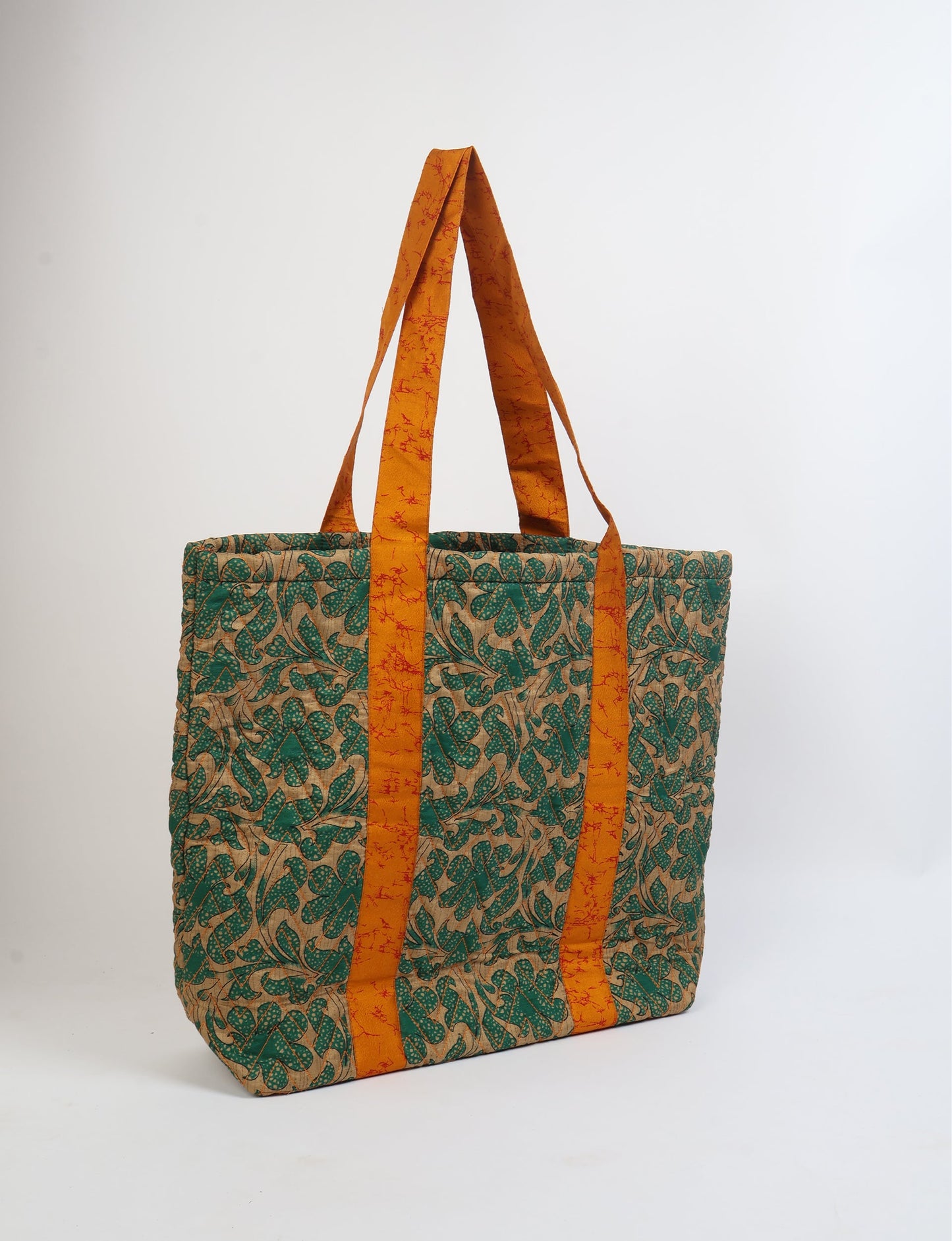 Elevate your style with our Quilted Tote Bag, a perfect fusion of fashion and sustainability. Made from vibrant upcycled saris, the newly quilted design adds strength and softness. With double fabric contrast straps and a unique sari lining, it's a statement of ethical elegance.