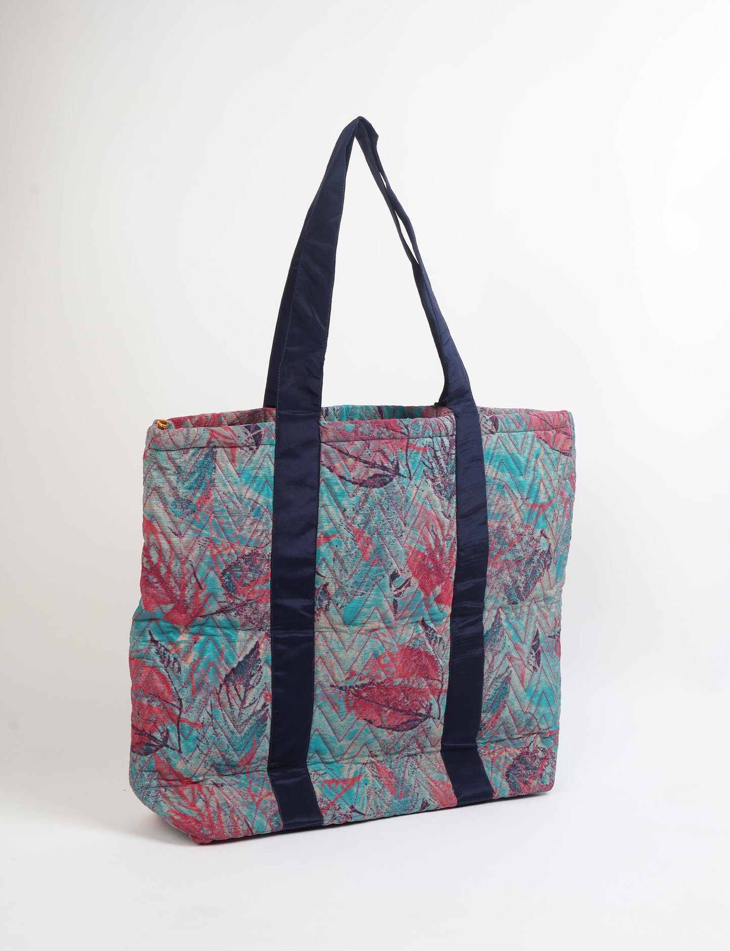 Elevate your style with our Quilted Tote Bag, a perfect fusion of fashion and sustainability. Made from vibrant upcycled saris, the newly quilted design adds strength and softness. With double fabric contrast straps and a unique sari lining, it's a statement of ethical elegance.