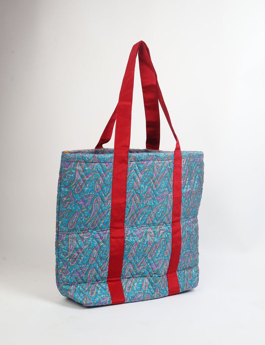 Elevate your style with our Quilted Tote Bag, a perfect fusion of fashion and sustainability. Made from vibrant upcycled saris, the newly quilted design adds strength and softness. With double fabric contrast straps and a unique sari lining, it's a statement of ethical elegance.