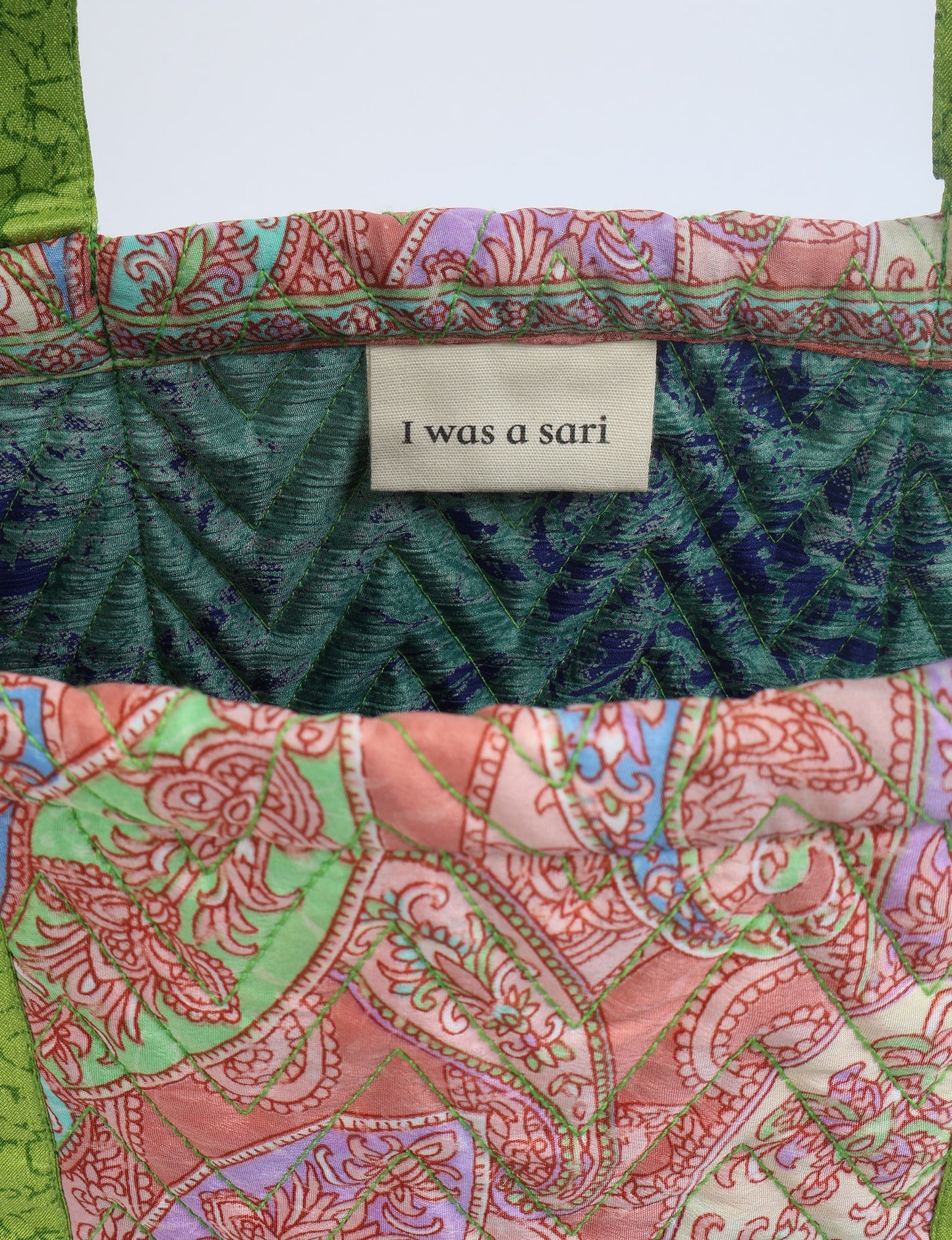 Elevate your style with our Quilted Tote Bag, a perfect fusion of fashion and sustainability. Made from vibrant upcycled saris, the newly quilted design adds strength and softness. With double fabric contrast straps and a unique sari lining, it's a statement of ethical elegance.