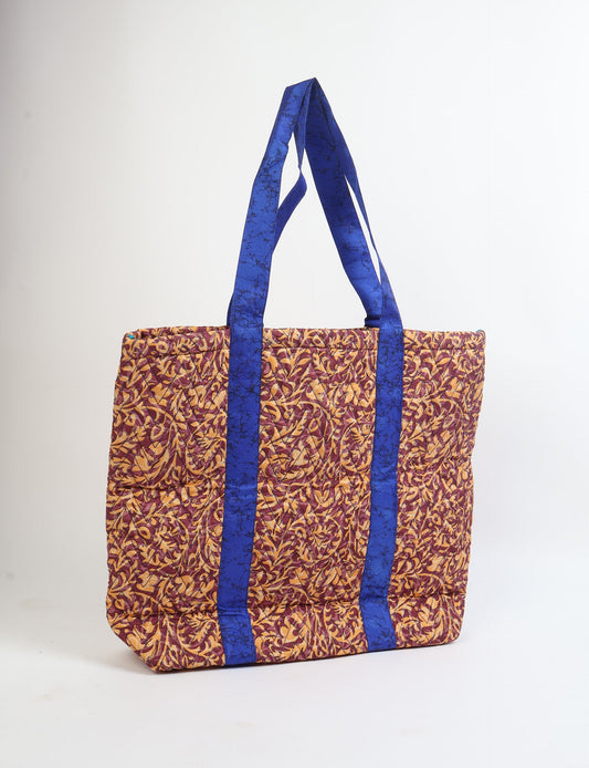 Elevate your style with our Quilted Tote Bag, a perfect fusion of fashion and sustainability. Made from vibrant upcycled saris, the newly quilted design adds strength and softness. With double fabric contrast straps and a unique sari lining, it's a statement of ethical elegance.